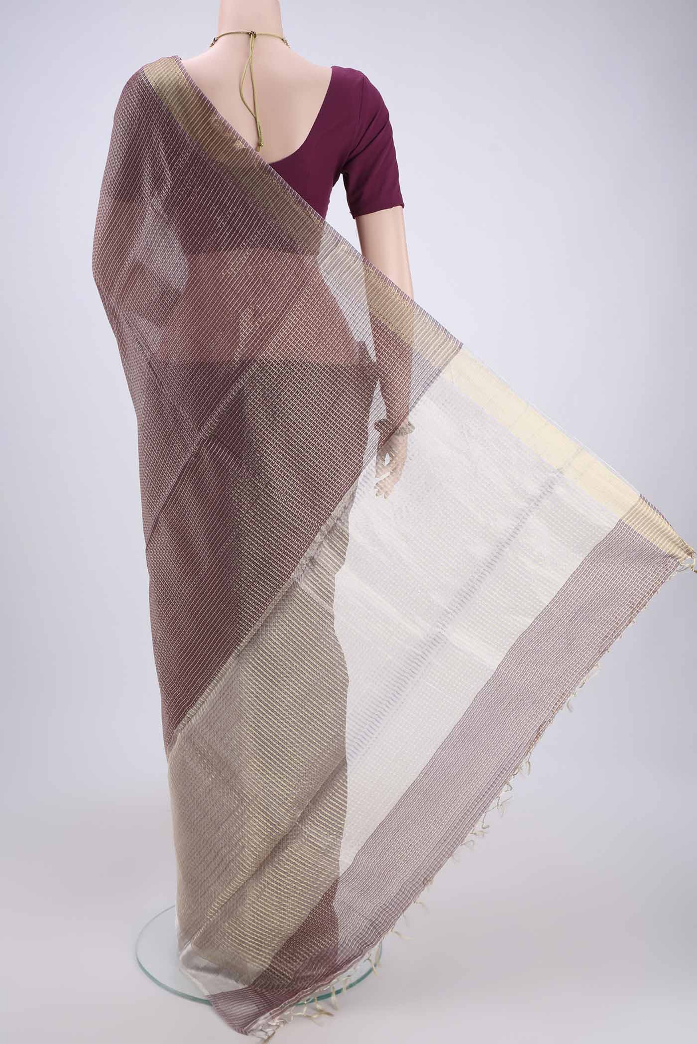 Flat view of Maroon MP Tussar Saree with Zari Butta on the body and Zari Border. 