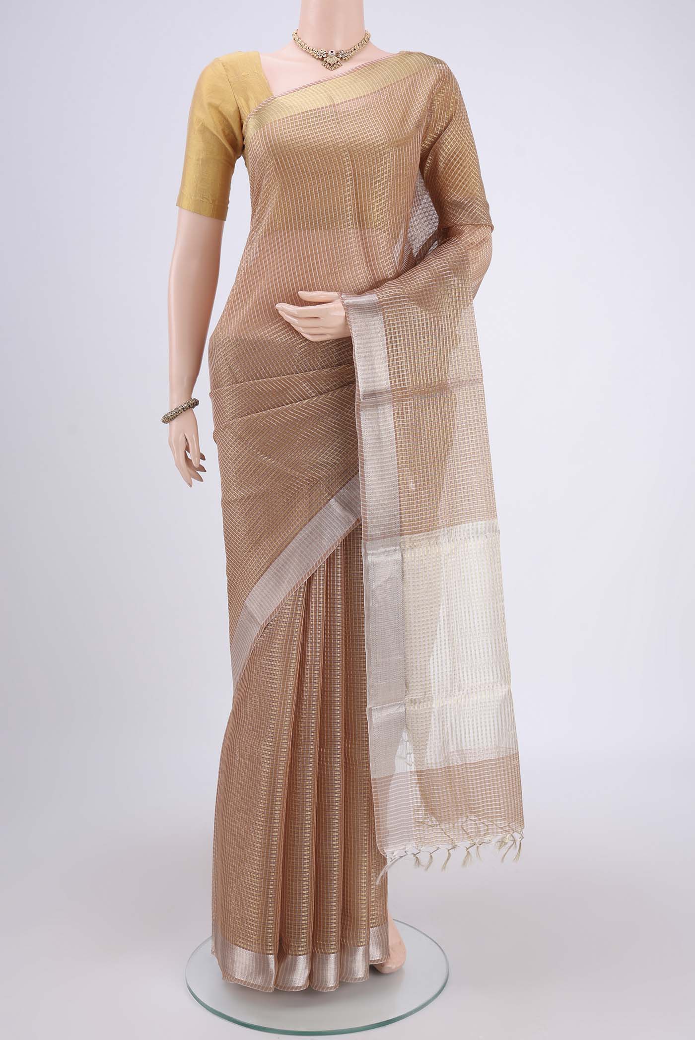 Peach MP Tussar Saree with Zari Butta on the body and Zari Border.  displayed on a mannequin