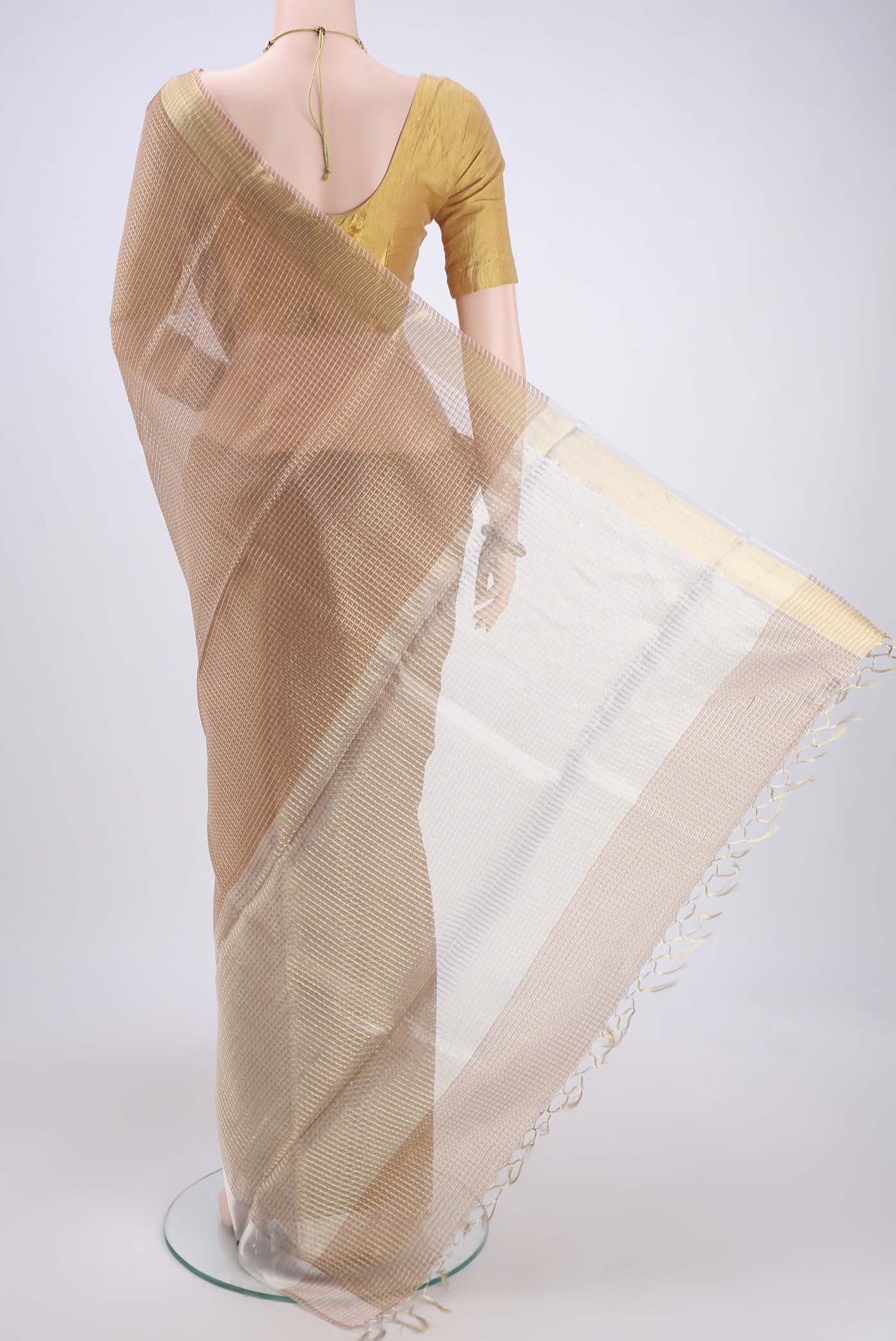 Flat view of Peach MP Tussar Saree with Zari Butta on the body and Zari Border. 