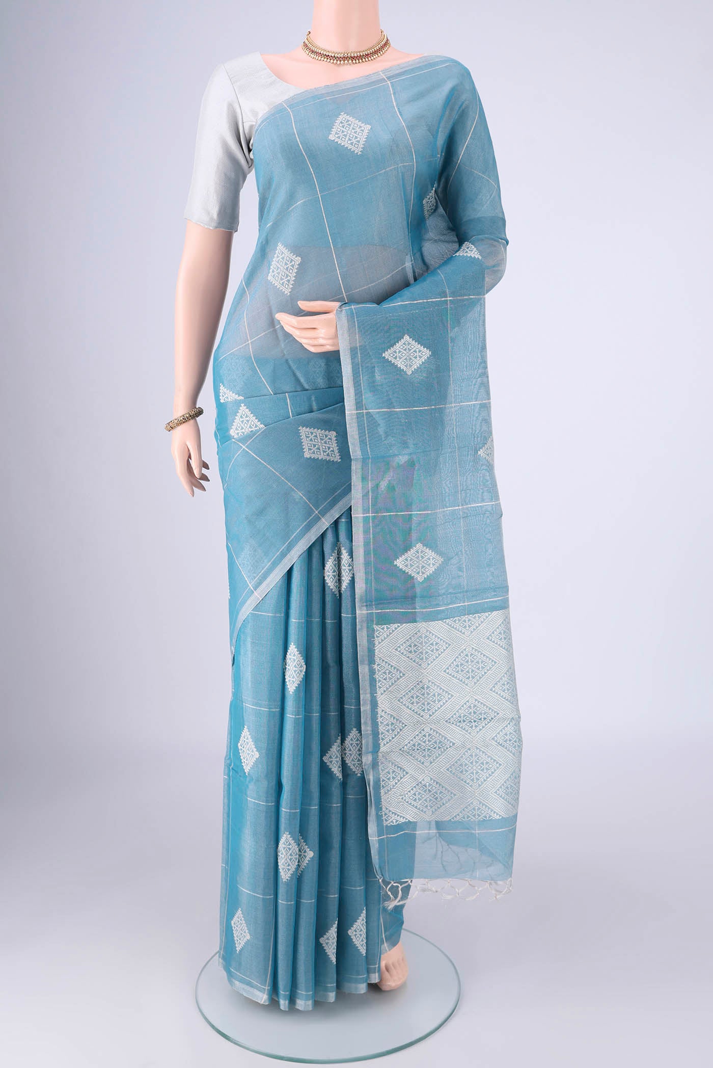 Light Blue MP Tussar Saree with Checked design on the body and Thin Zari Line.  displayed on a mannequin