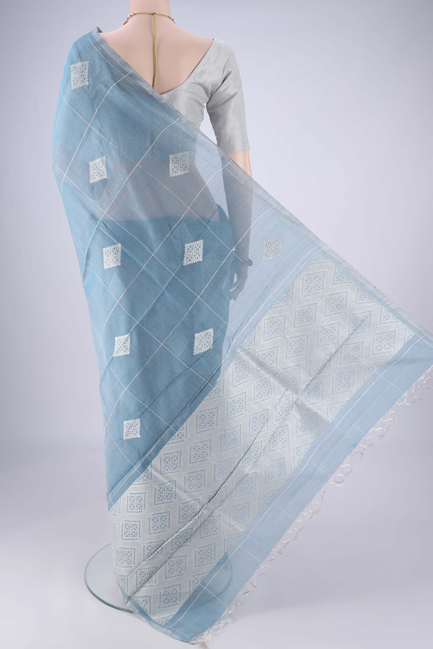 Flat view of Light Blue MP Tussar Saree with Checked design on the body and Thin Zari Line. 