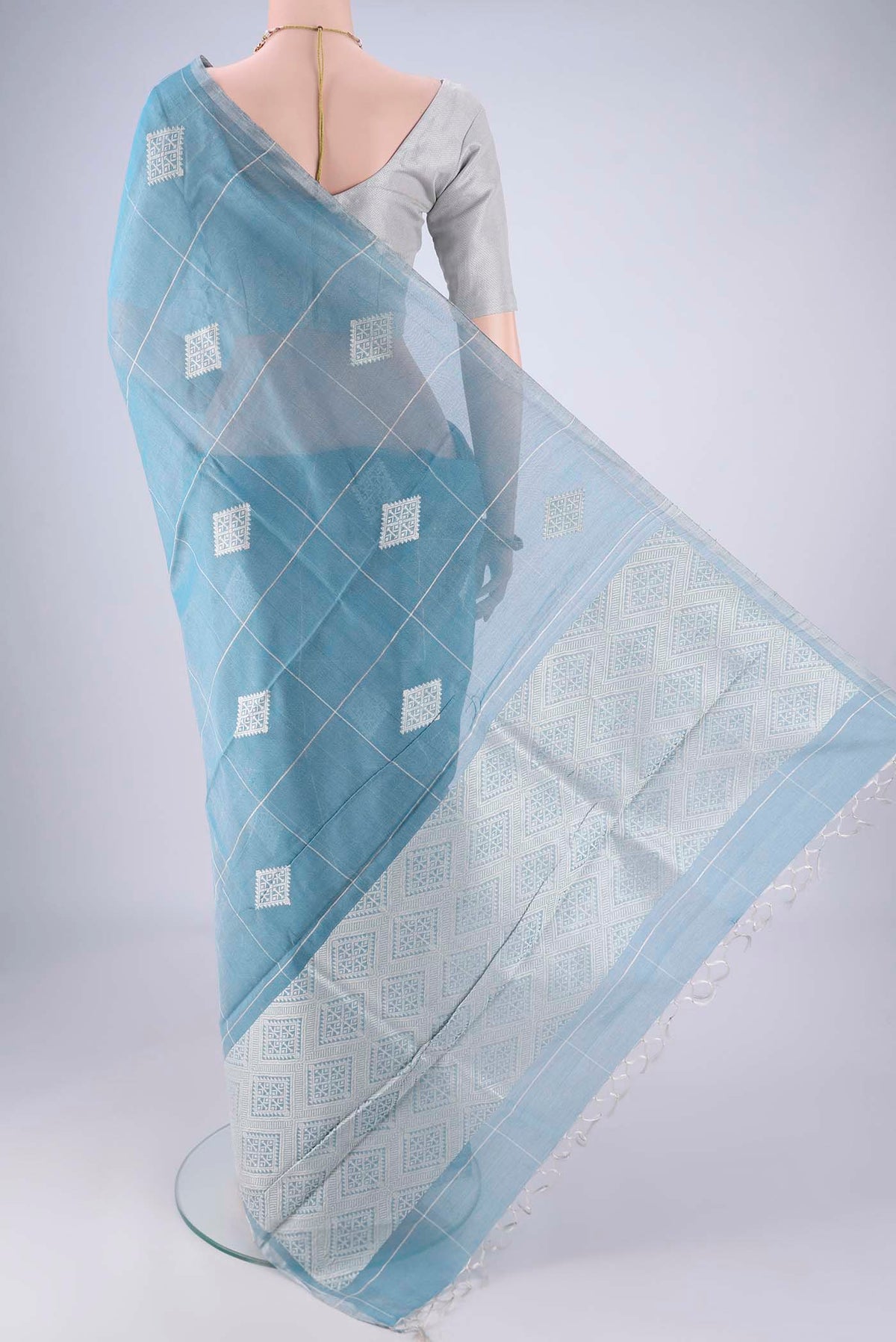 Flat view of Light Blue MP Tussar Saree with Checked design on the body and Thin Zari Line. 