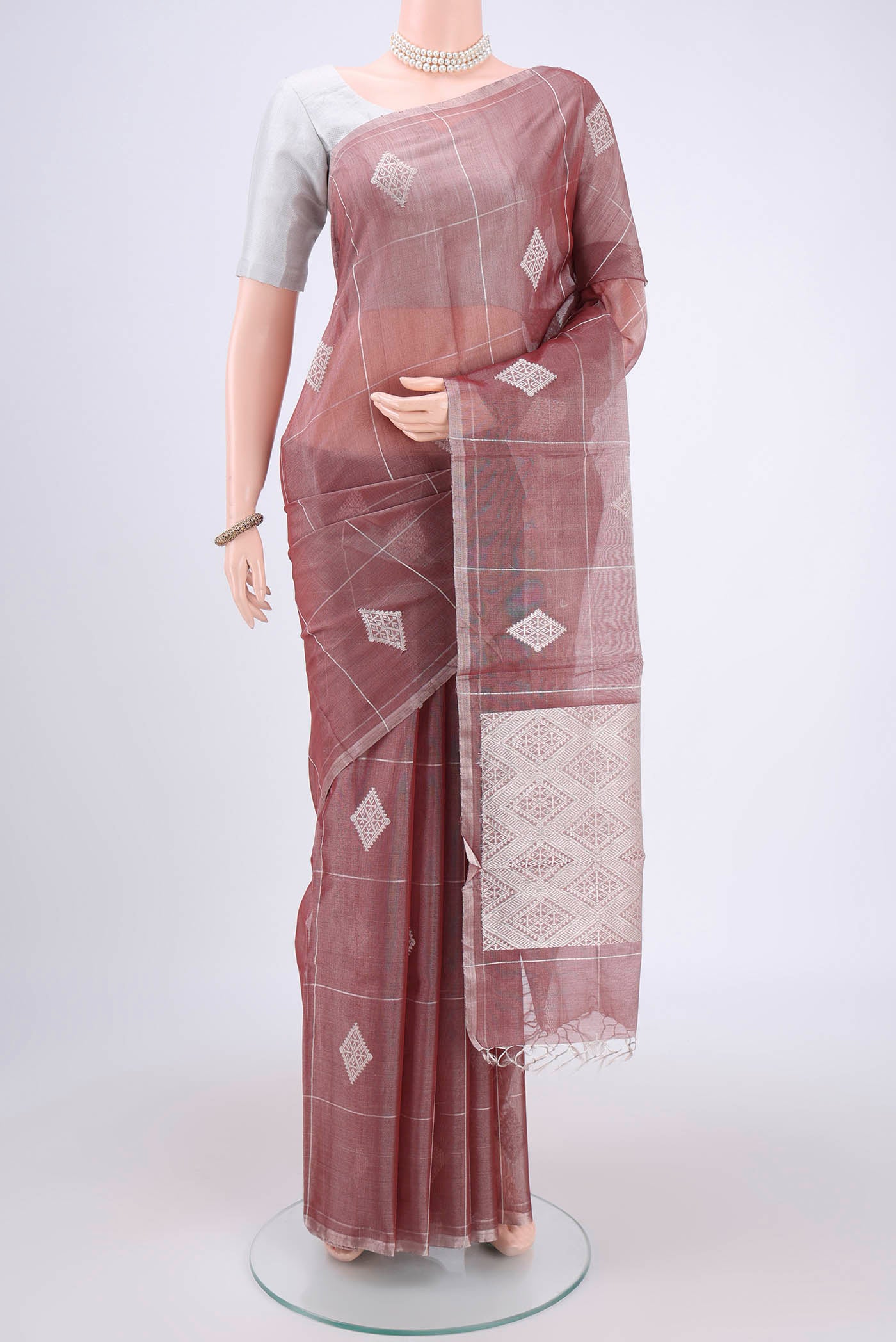 Mauve MP Tussar Saree with Zari Butta on the body and Zari Border.  displayed on a mannequin