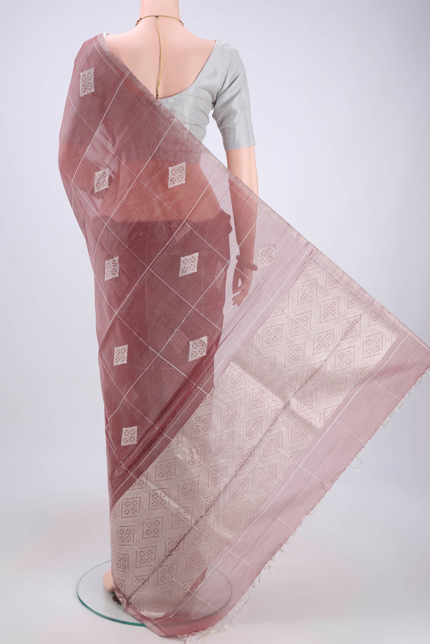 Flat view of Mauve MP Tussar Saree with Zari Butta on the body and Zari Border. 