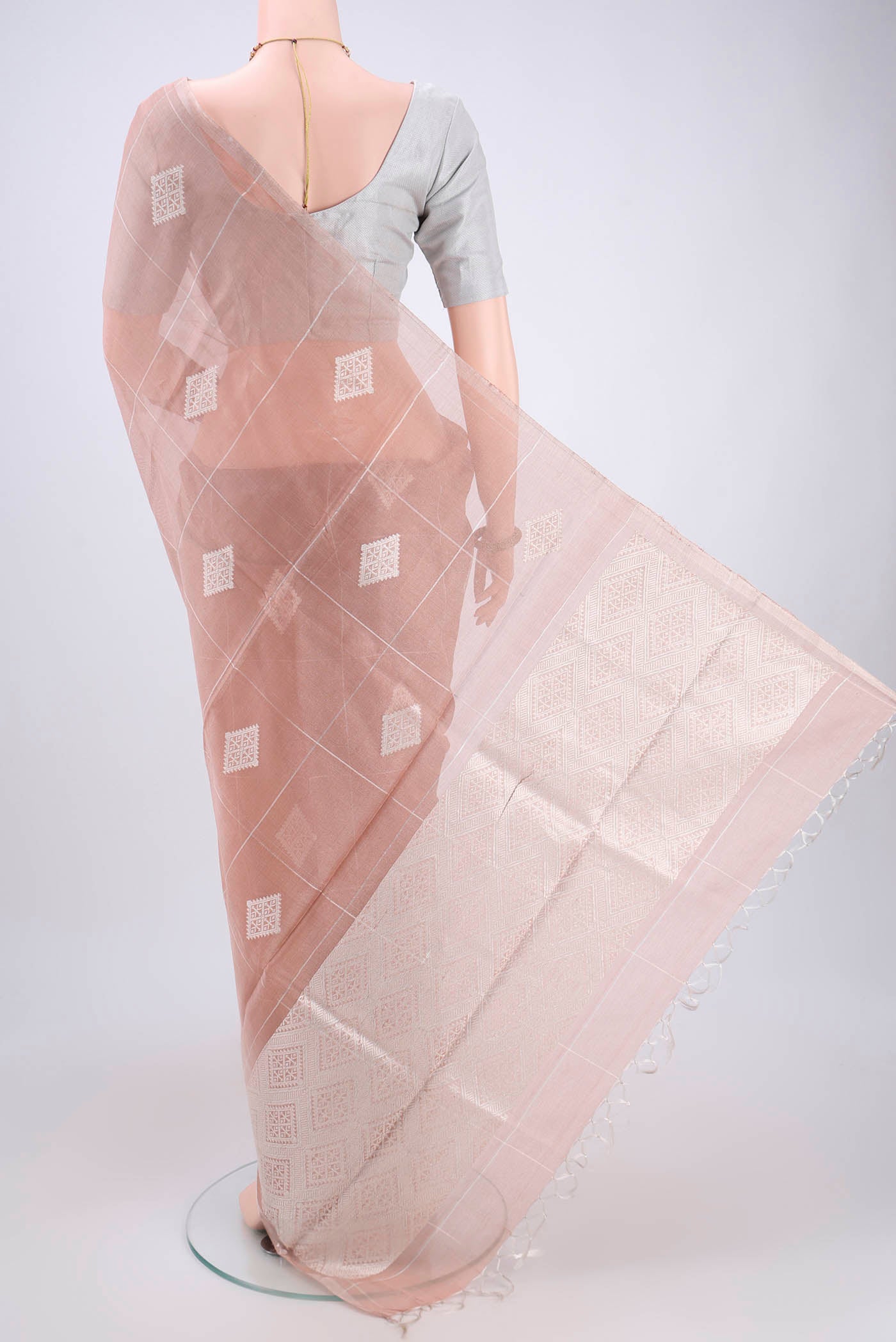 Flat view of Peach MP Tussar Saree with Zari Butta on the body and Zari Border. 