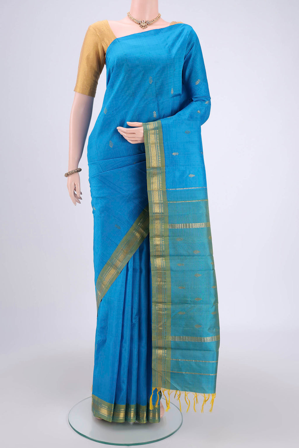 Blue Kanchipuram Silk Saree with Zari Butta on the body and One Side Border.  displayed on a mannequin