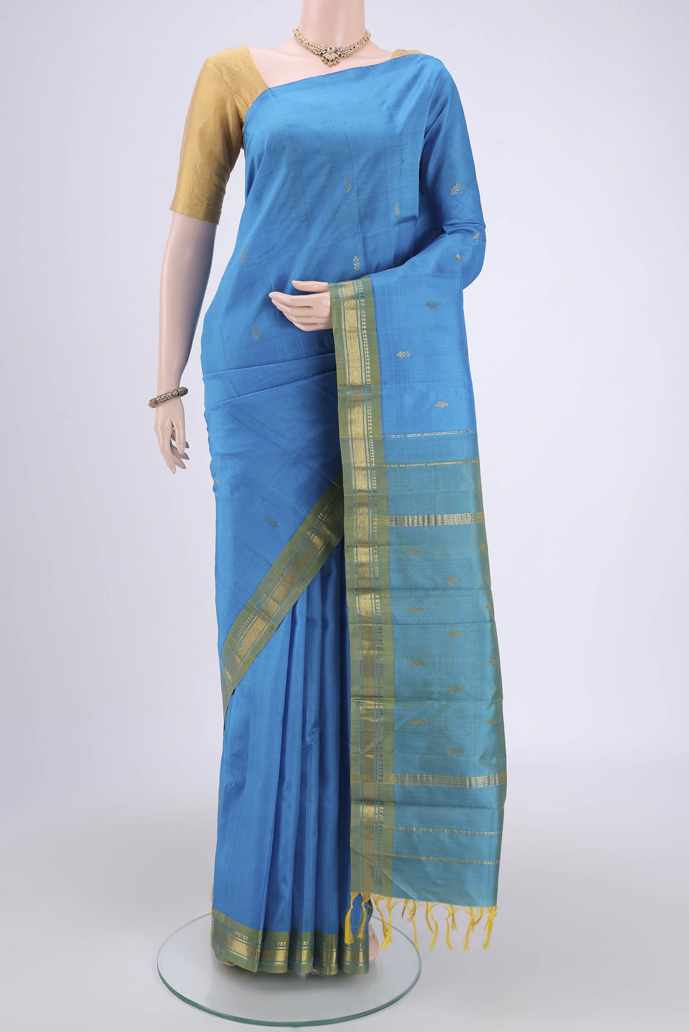 Blue Kanchipuram Silk Saree with Zari Butta on the body and One Side Border.  displayed on a mannequin