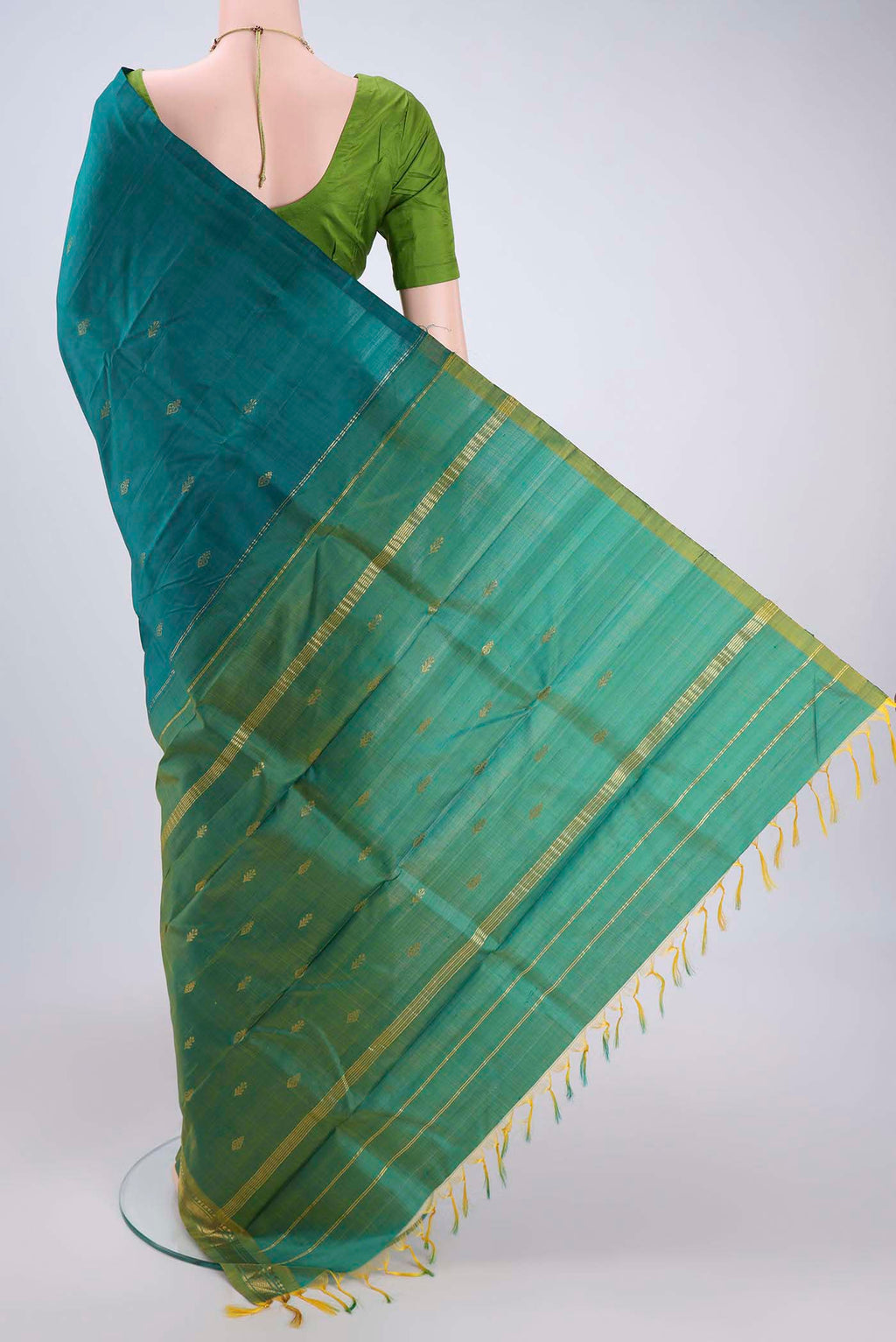 Flat view of Sea Green Kanchipuram Silk Saree with Zari Butta on the body and Zari Border. 