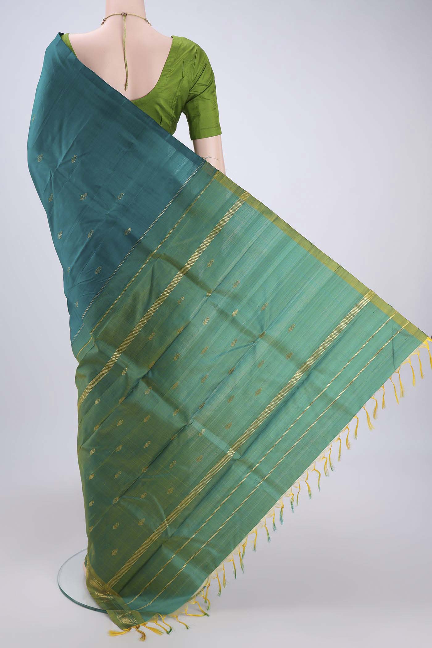 Flat view of Sea Green Kanchipuram Silk Saree with Zari Butta on the body and Zari Border. 