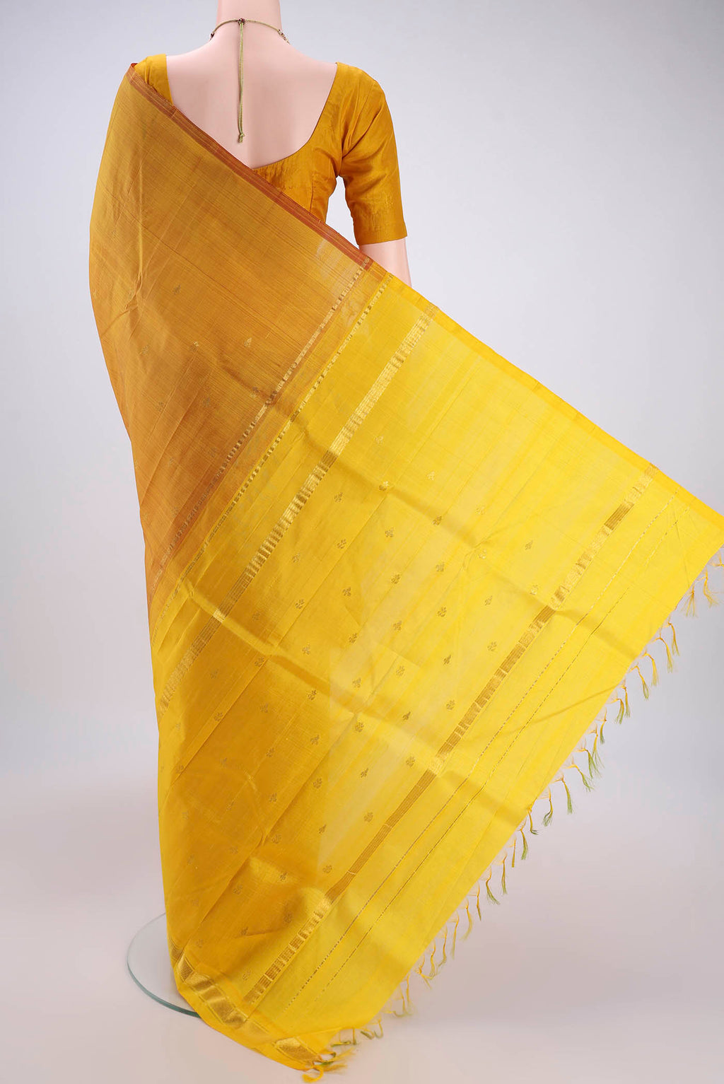Flat view of Yellow Kanchipuram Silk Saree with Zari Butta on the body and One Side Border. 