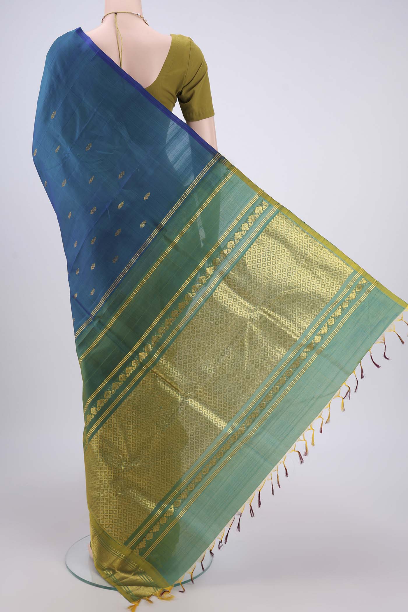Flat view of Peacock Blue Kanjivaram Silk Saree with Zari Butta on the body and One Side Border. 