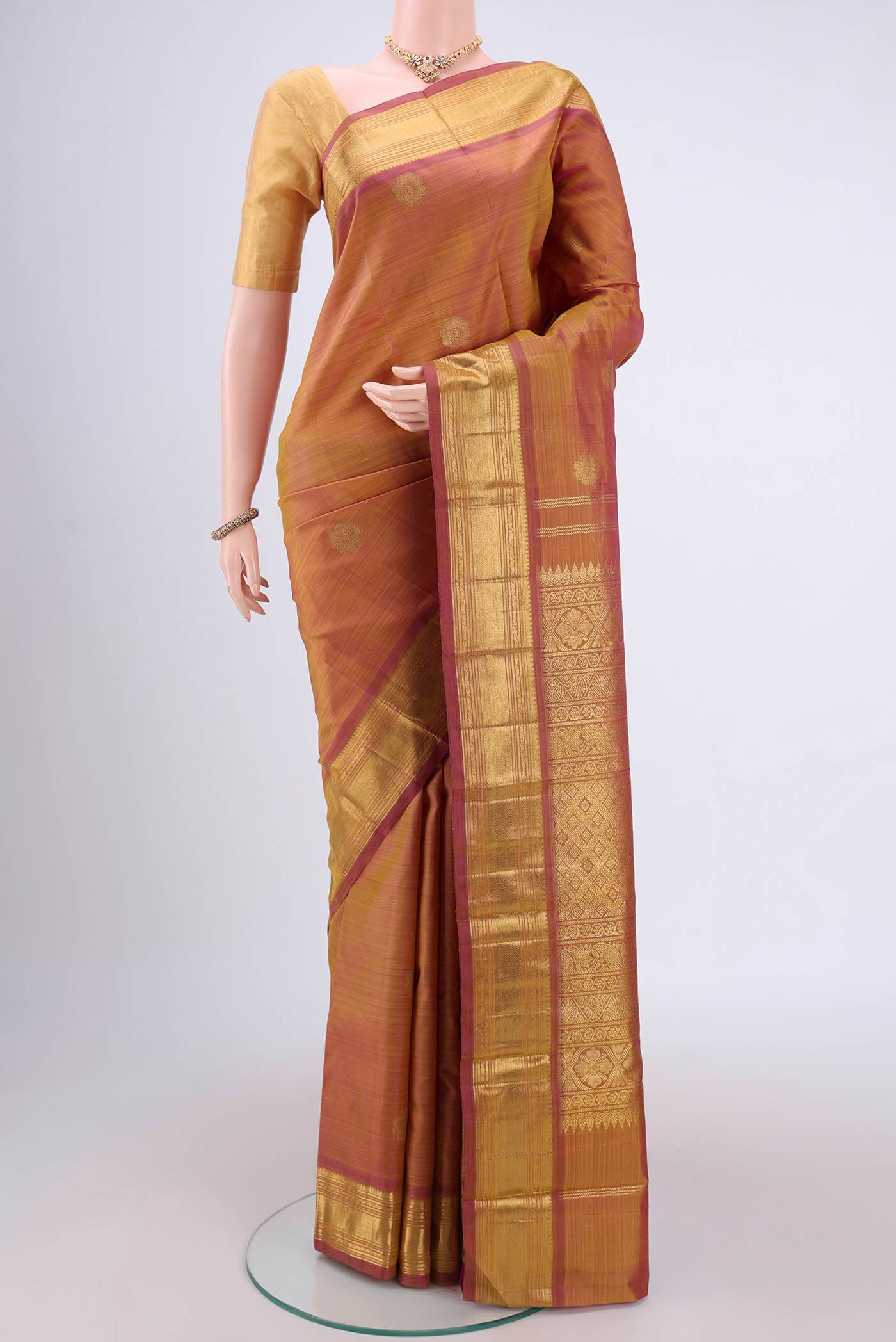 Pure Silk Pure Zari Magenta Kanchipuram Saree with Zari Butta on the body and Zari Border.  displayed on a mannequin
