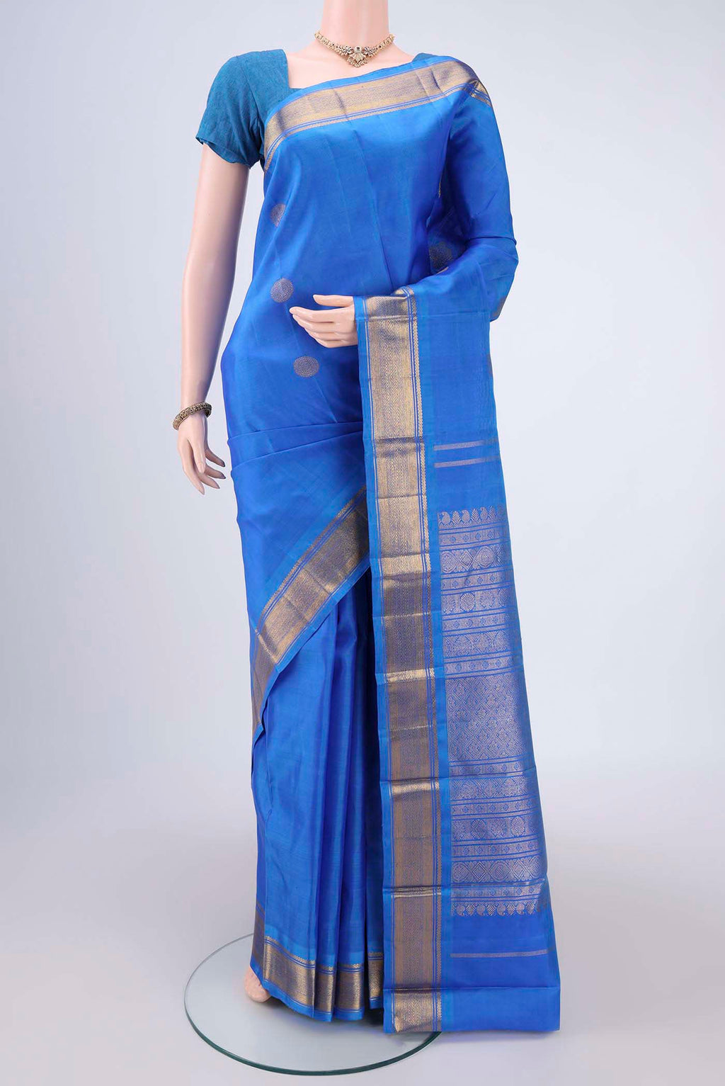 Blue Kanchipuram Silk Saree with Zari Butta on the body and Zari Border.  displayed on a mannequin
