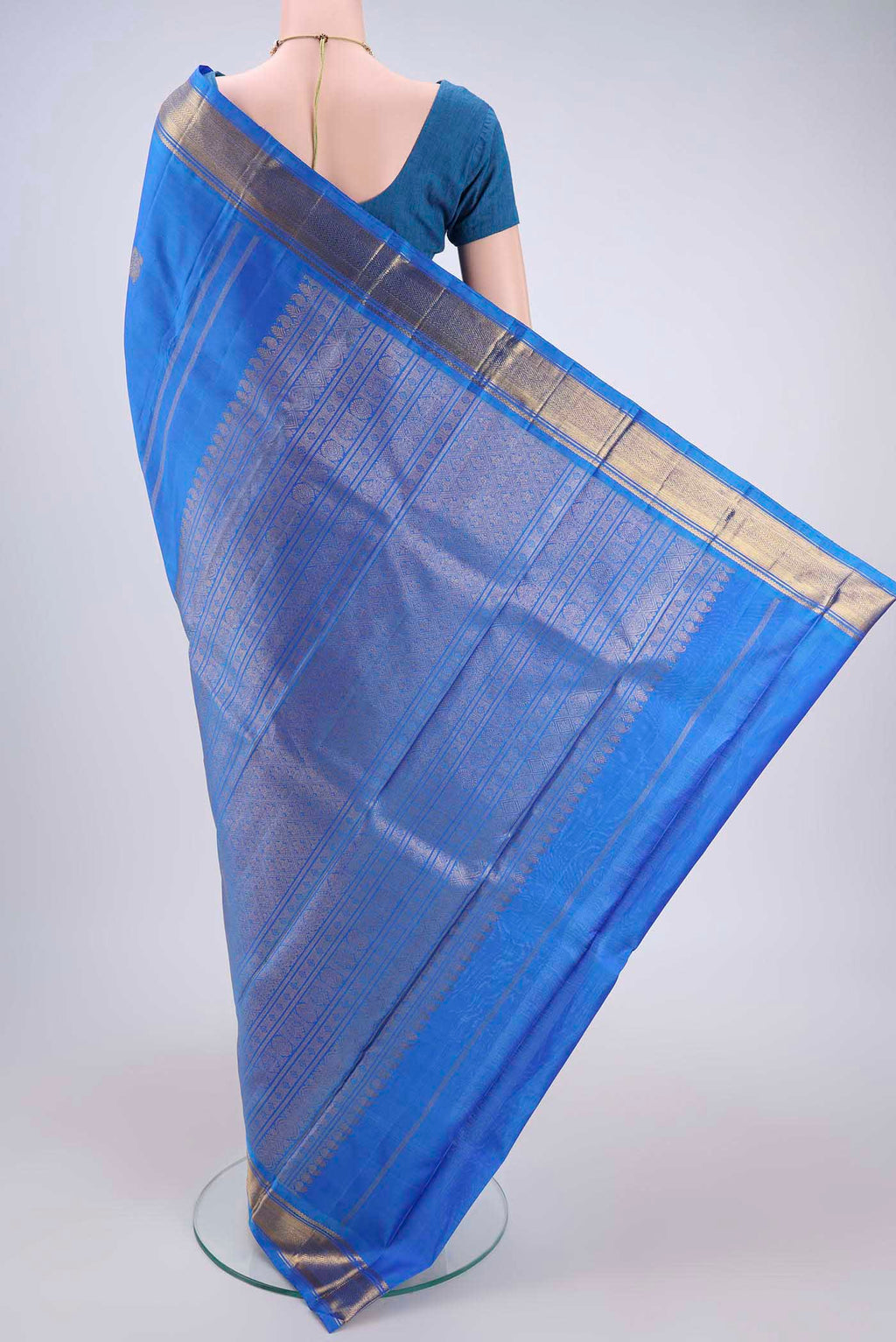 Flat view of Blue Kanchipuram Silk Saree with Zari Butta on the body and Zari Border. 