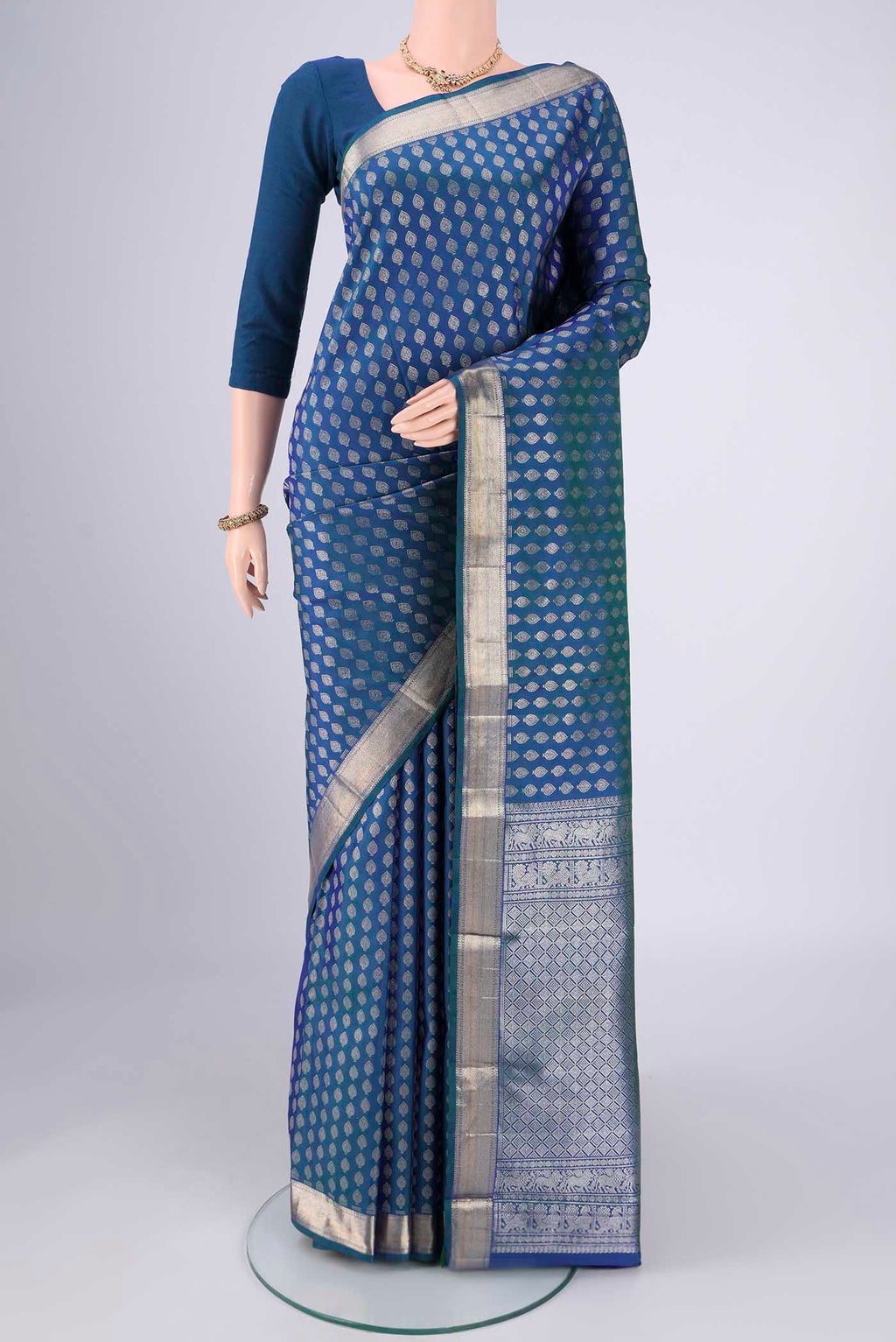 Blue Dual Tone Kanchipuram Silk Saree with Zari Butta on the body and Zari Border.  displayed on a mannequin