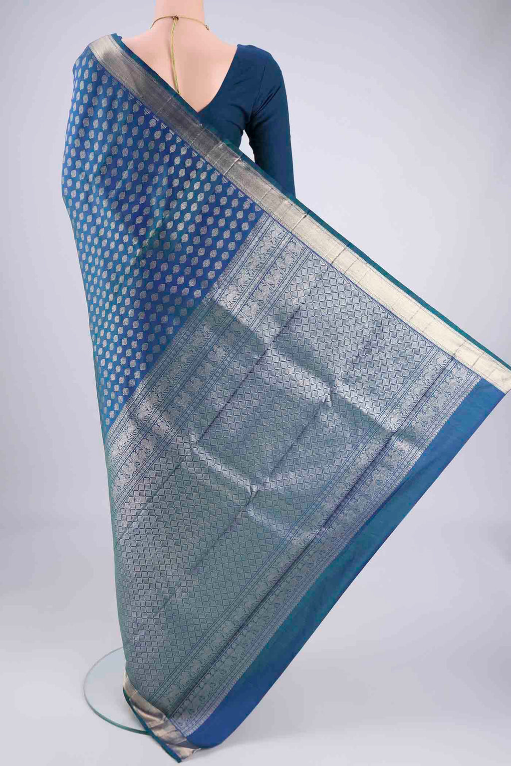 Flat view of Blue Dual Tone Kanchipuram Silk Saree with Zari Butta on the body and Zari Border. 