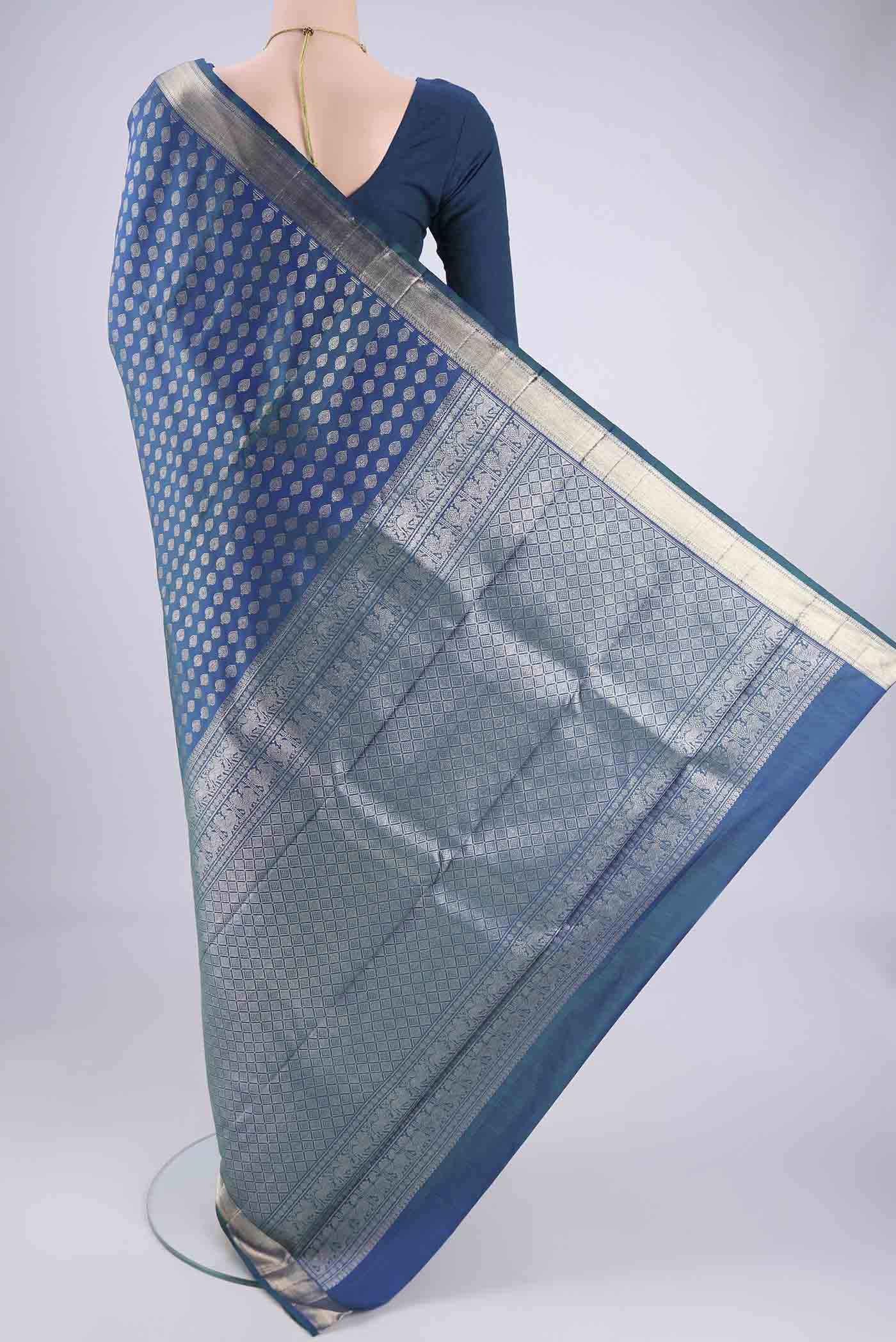 Flat view of Blue Dual Tone Kanchipuram Silk Saree with Zari Butta on the body and Zari Border. 