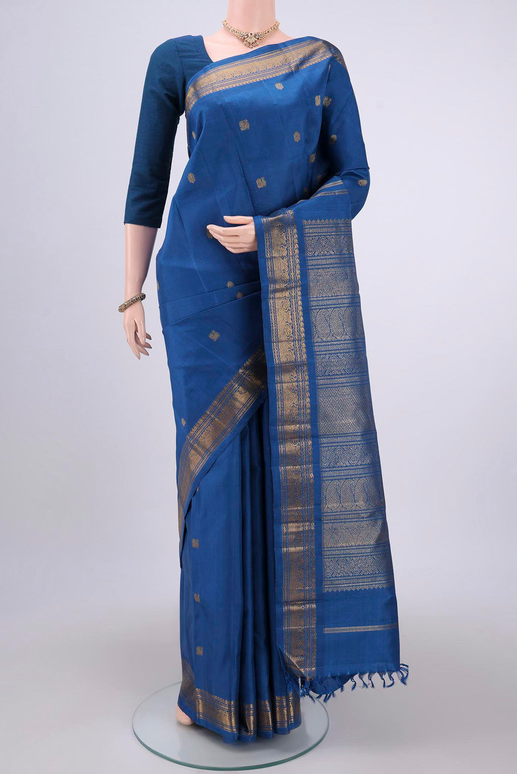 Pure Silk Pure Zari Blue Kanchipuram Saree with Zari Butta on the body and Zari Border.  displayed on a mannequin