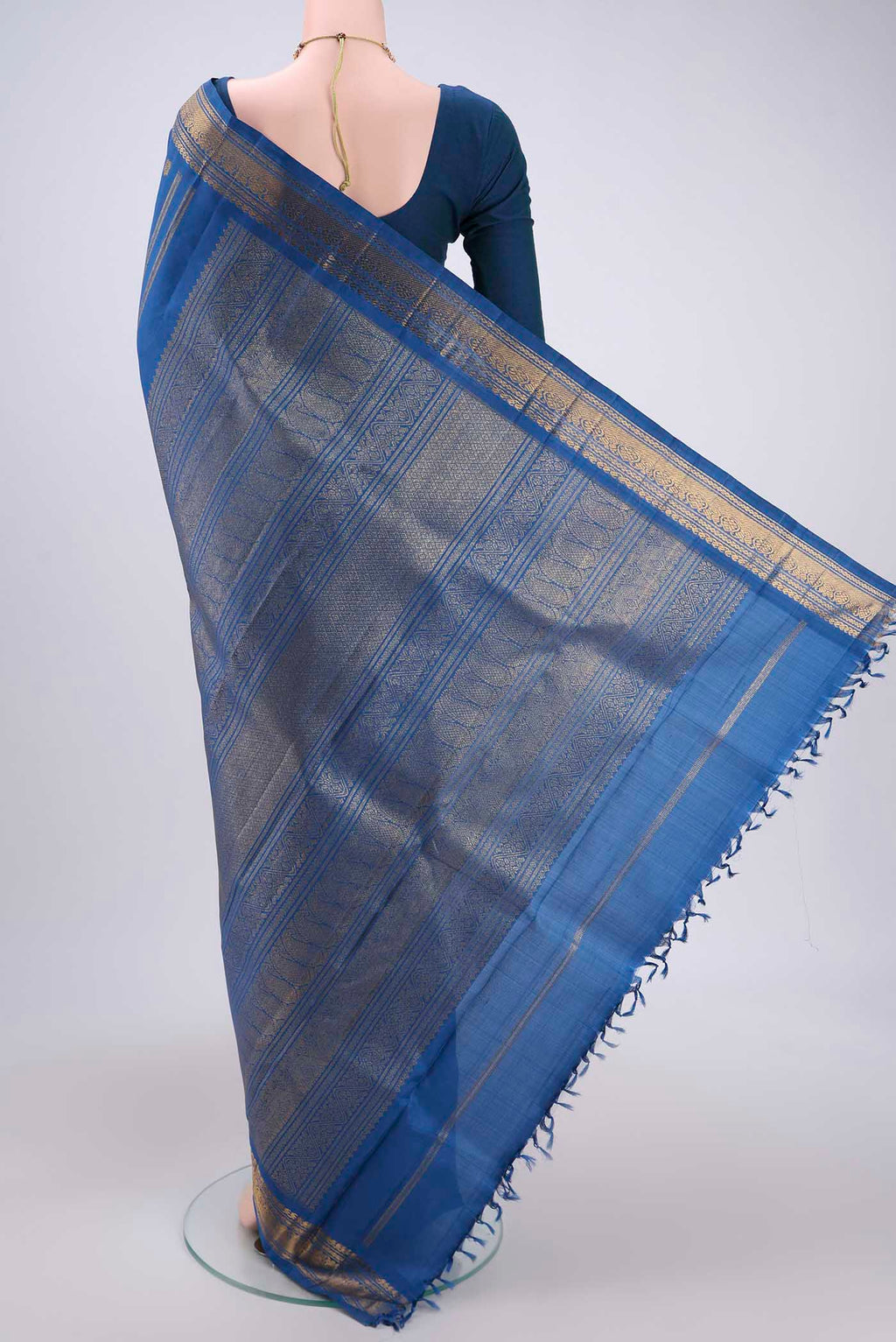 Flat view of Pure Silk Pure Zari Blue Kanchipuram Saree with Zari Butta on the body and Zari Border. 