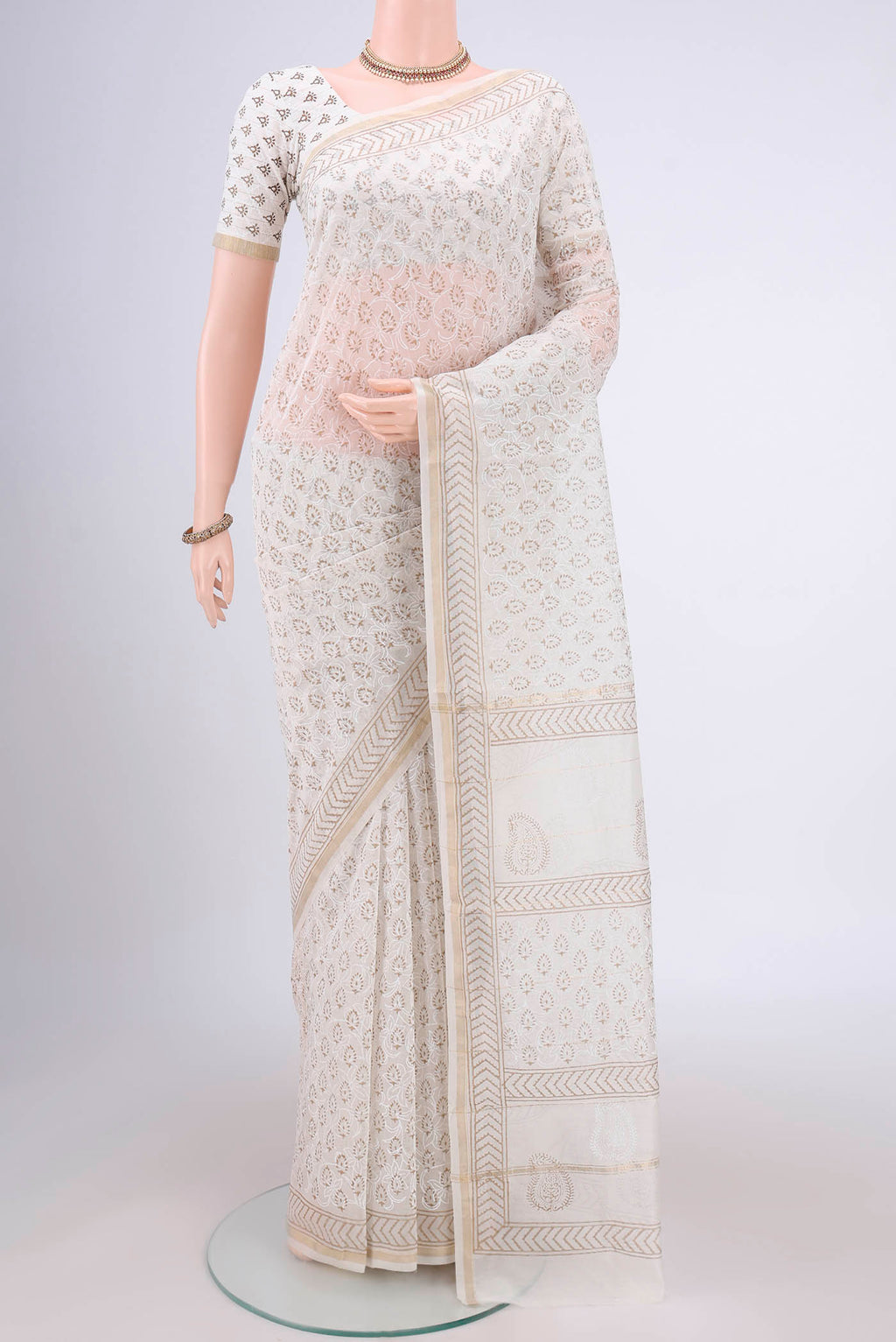 Off White Maheshwari Silk Cotton Saree with Printed design on the body and Thin Zari Line.  displayed on a mannequin
