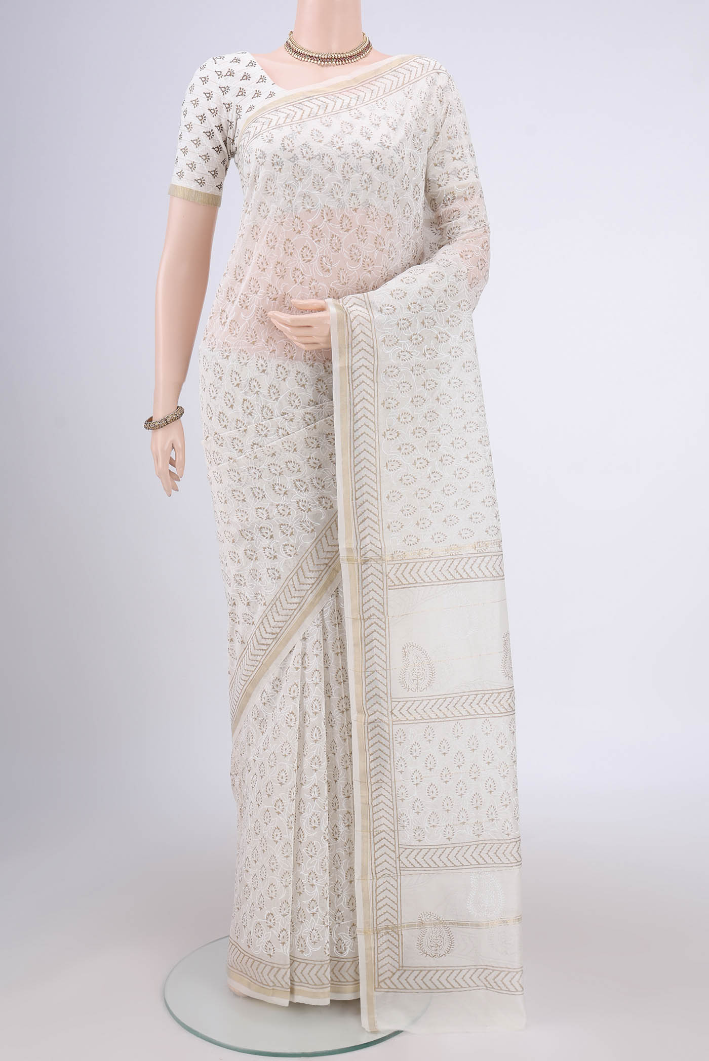 Off White Maheshwari Silk Cotton Saree with Printed design on the body and Thin Zari Line.  displayed on a mannequin