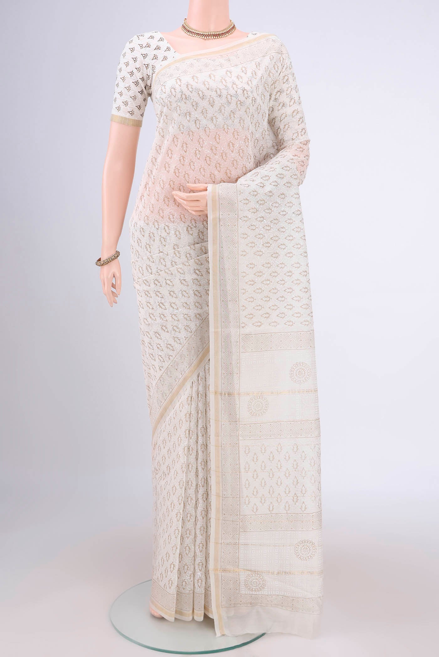 Off White Maheshwari Silk Cotton Saree with Printed design on the body and Thin Zari Line.  displayed on a mannequin