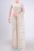 Off White Maheshwari Silk Cotton Saree with Batik Print on the body and Zari Border.  displayed on a mannequin