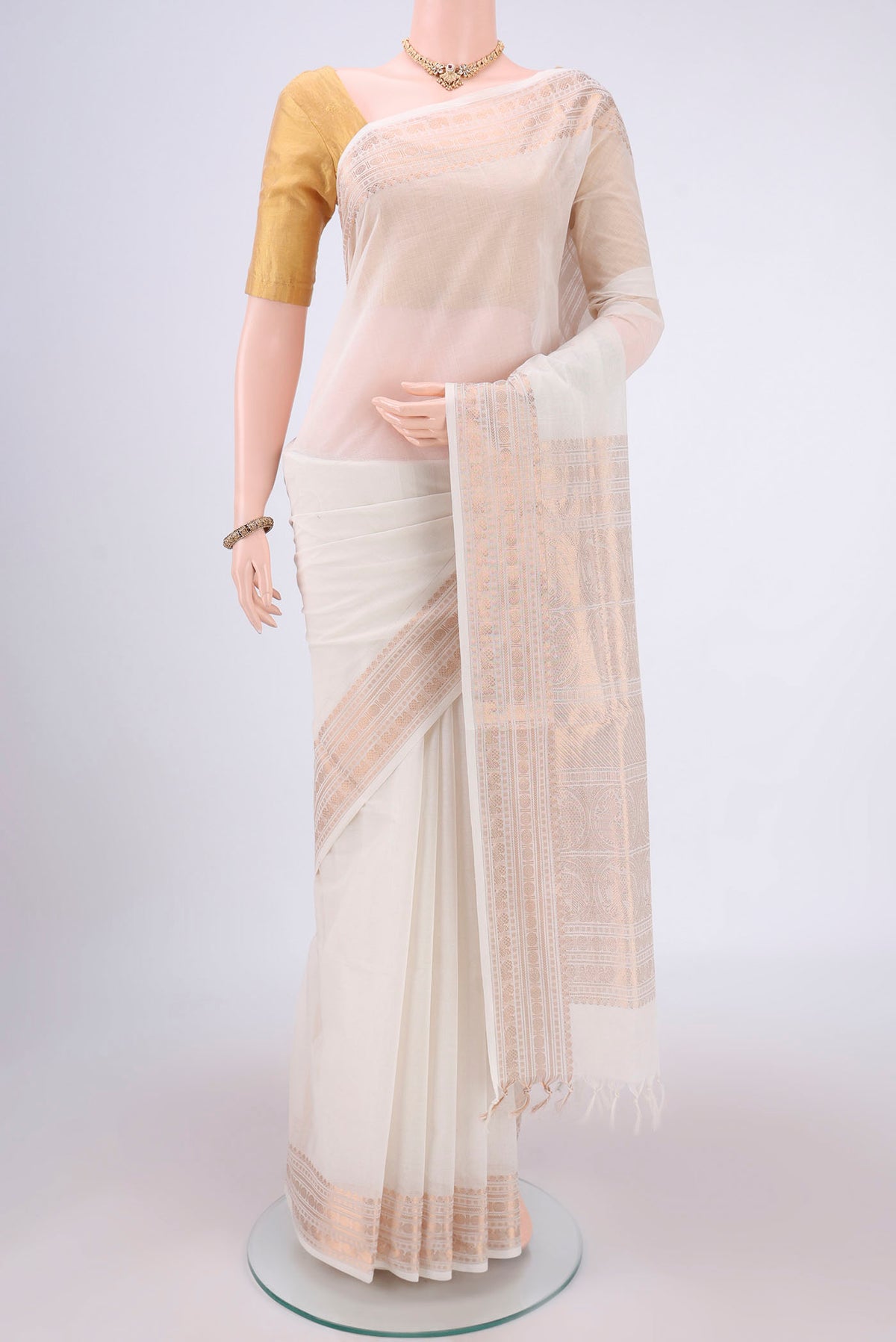 Off White Kanchi Cotton Saree with Plain Body and Zari Border.  displayed on a mannequin