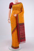Mustard Coimbatore Cotton Saree with Stripes on the body and Thread Border.  displayed on a mannequin