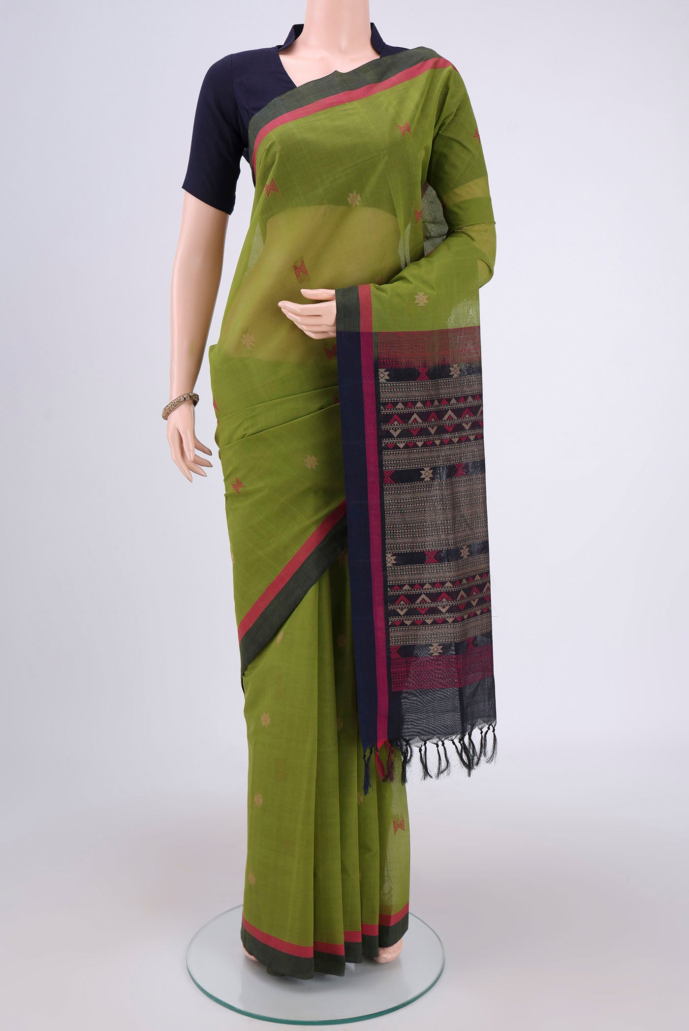 Mehandi Green Coimbatore Cotton Saree with Stripes on the body and Thread Border.  displayed on a mannequin