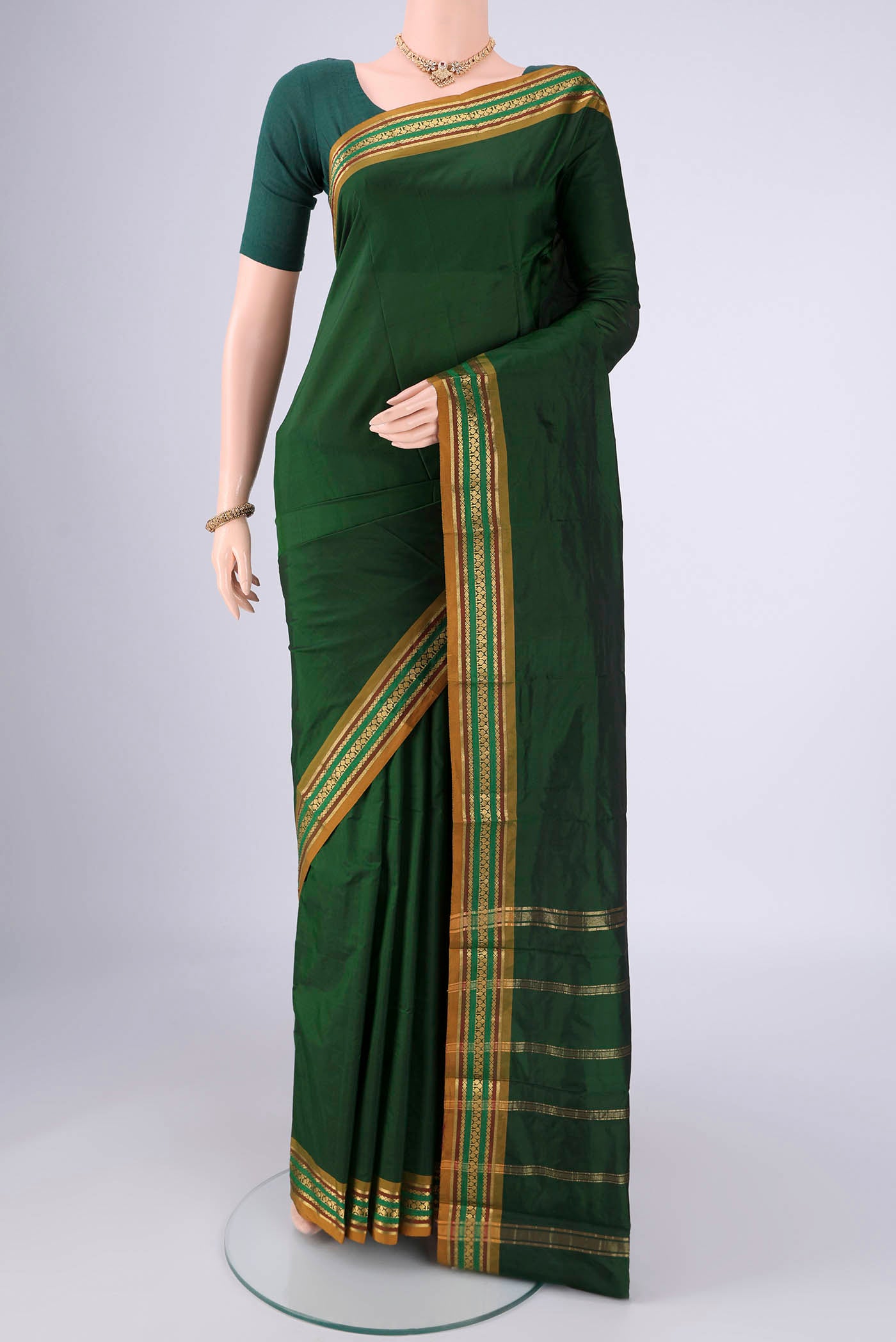 Bottle Green Blended Bangalore Silk Saree with Jacquard design on the body and Zari Border.  displayed on a mannequin