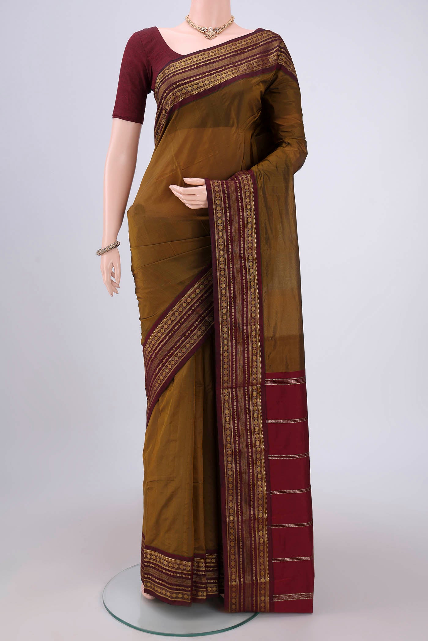Mehandi Green Blended Bangalore Silk Saree with Plain Body and Zari Border.  displayed on a mannequin