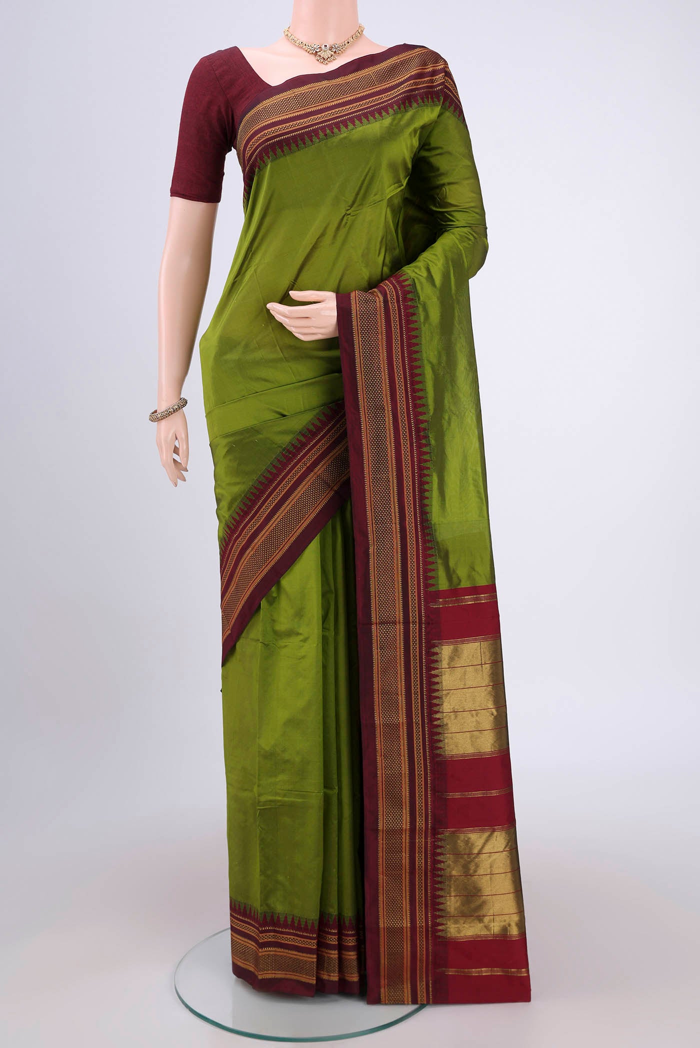 Green Blended Bangalore Silk Saree with Plain Body and Temple Border.  displayed on a mannequin