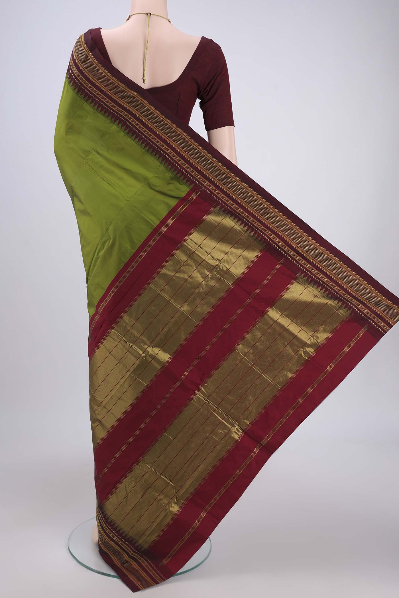 Flat view of Green Blended Bangalore Silk Saree with Plain Body and Temple Border. 