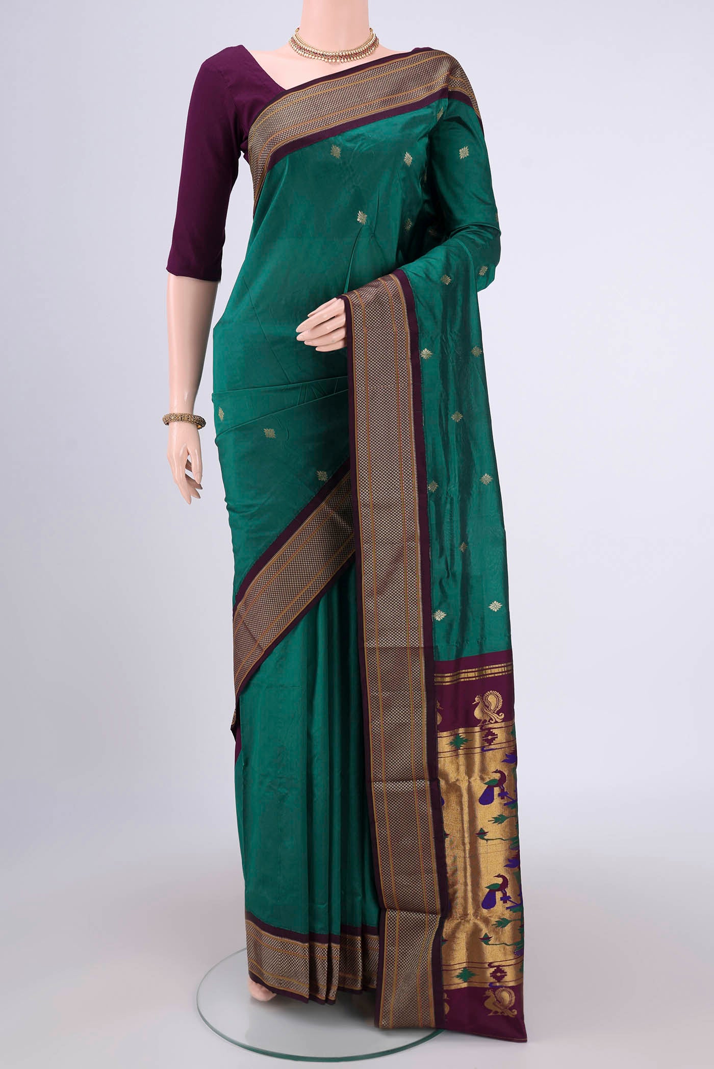 Bottle Green Blended Bangalore Silk Saree with Zari Butta on the body and Zari Border.  displayed on a mannequin