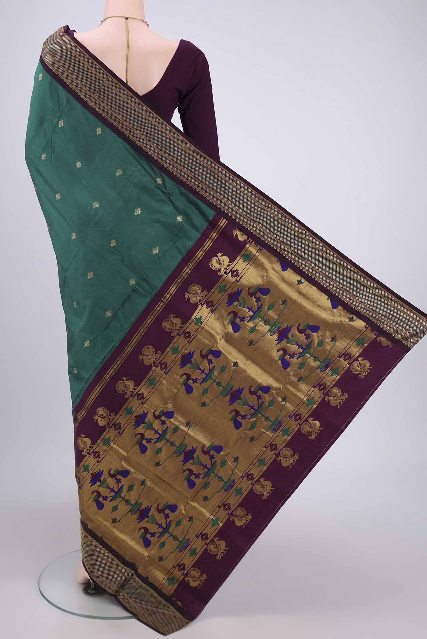Flat view of Bottle Green Blended Bangalore Silk Saree with Zari Butta on the body and Zari Border. 