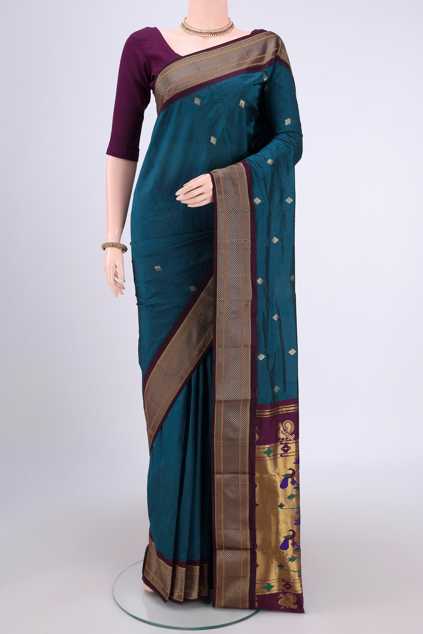 Green Blended Bangalore Silk Saree with Zari Butta on the body and Zari Border.  displayed on a mannequin