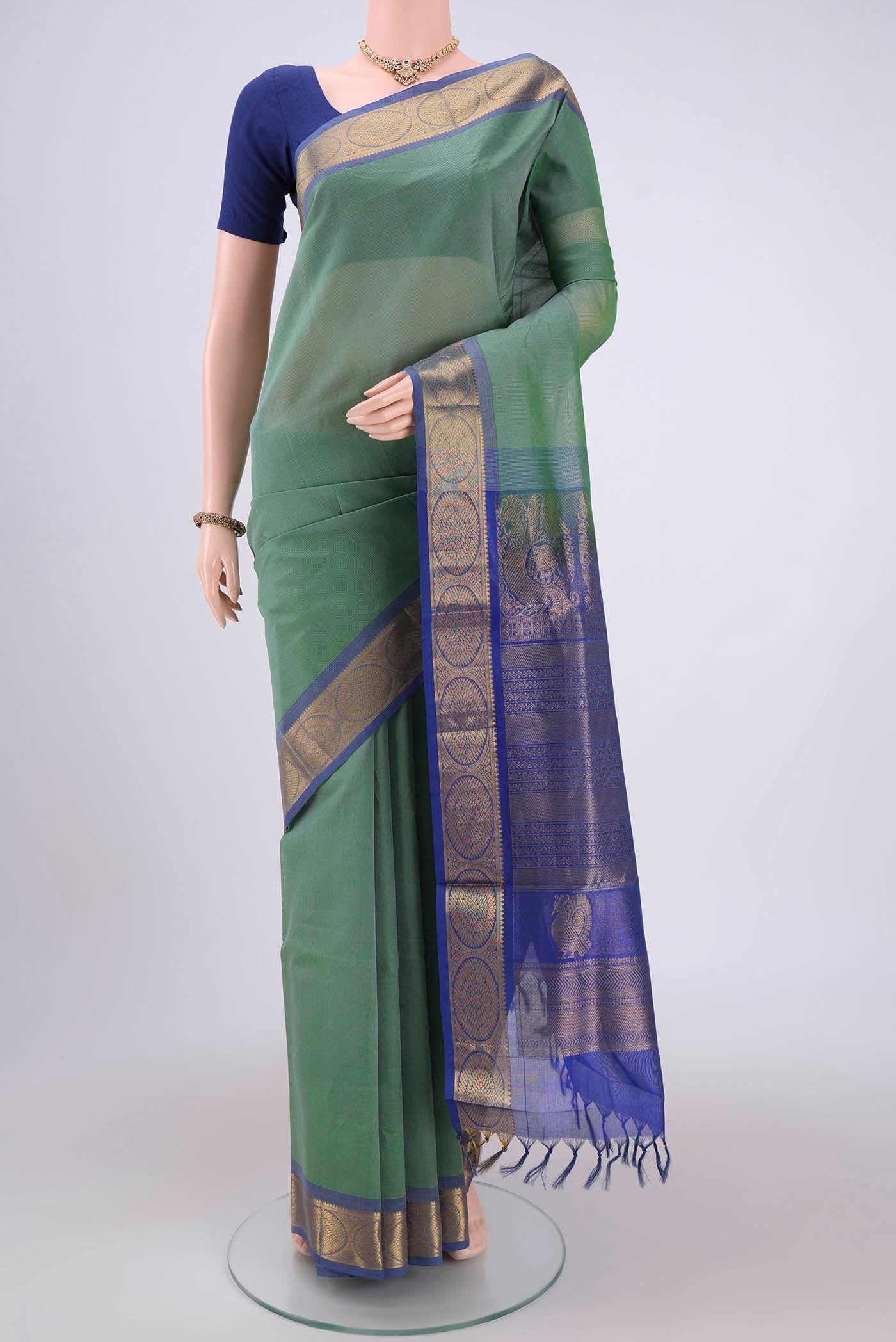 Sea Green Silk Cotton Saree with Plain Body and Zari Border.  displayed on a mannequin