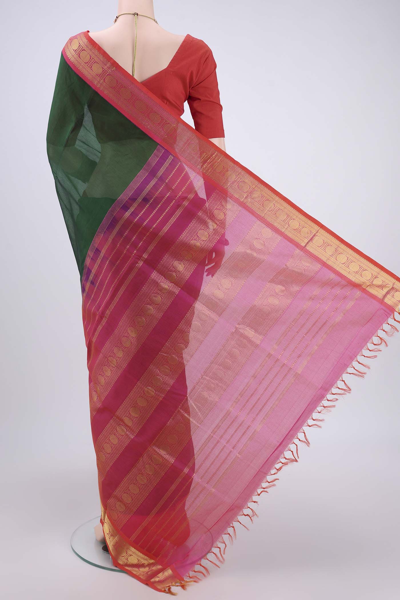 Flat view of Bottle Green Silk Cotton Saree with Plain Body and Zari Border. 