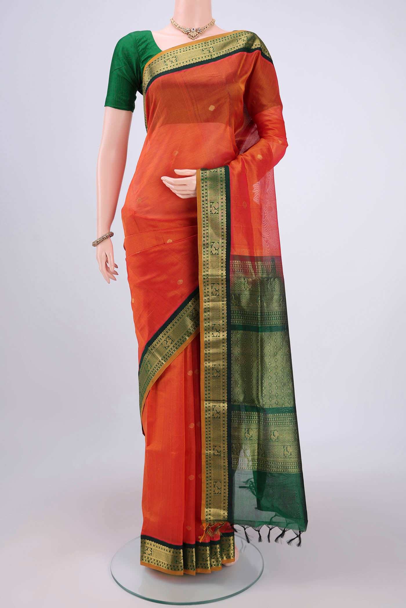Orange Silk Cotton Saree with Plain Body and Zari Border.  displayed on a mannequin