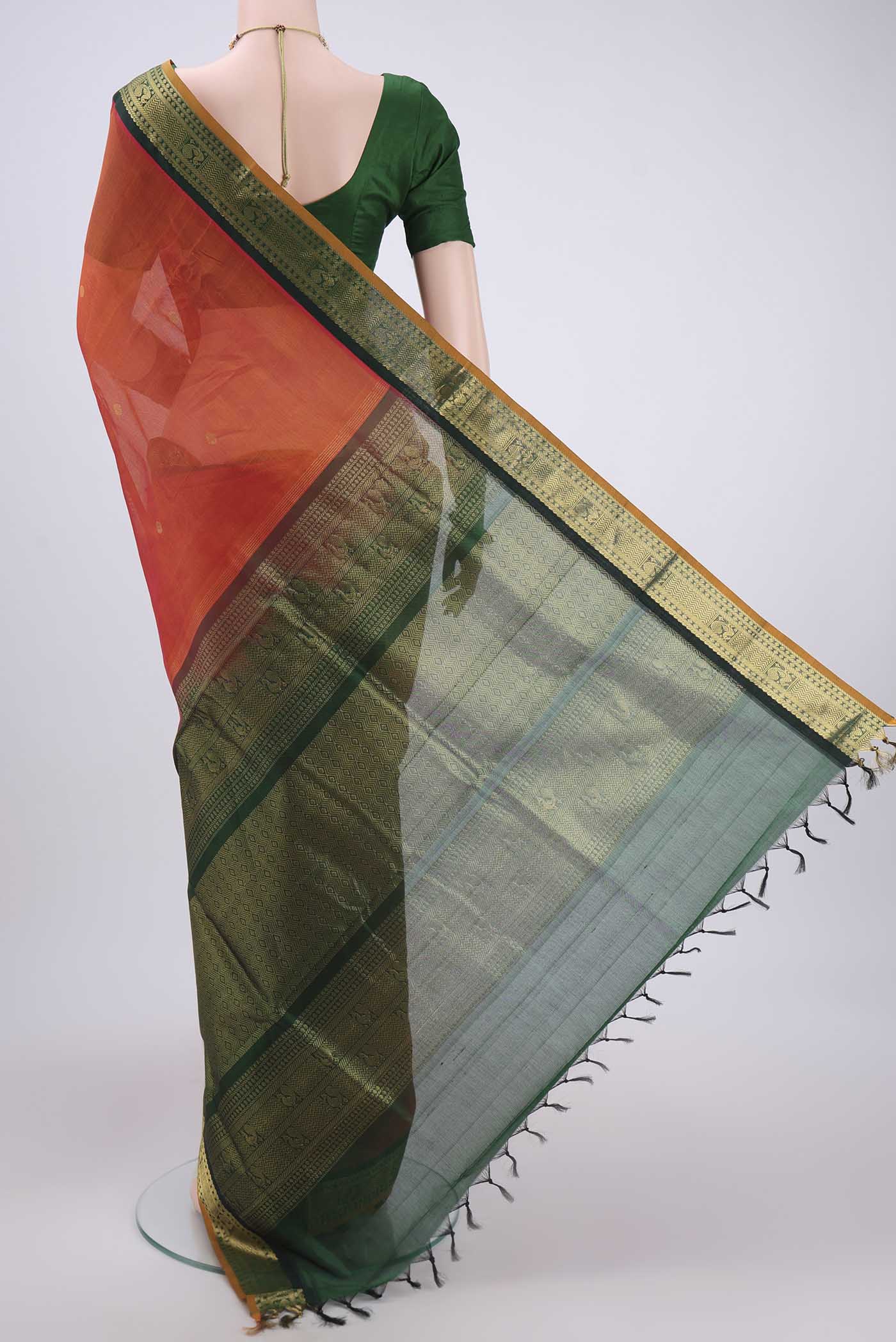 Flat view of Orange Silk Cotton Saree with Plain Body and Zari Border. 
