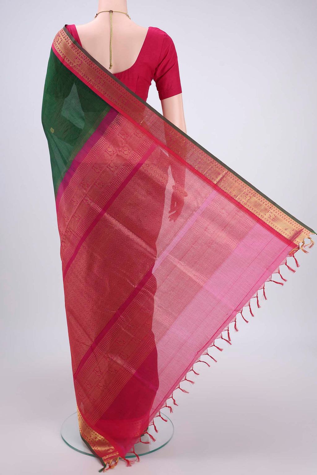 Flat view of Bottle Green Silk Cotton Saree with Zari Butta on the body and Zari Border. 