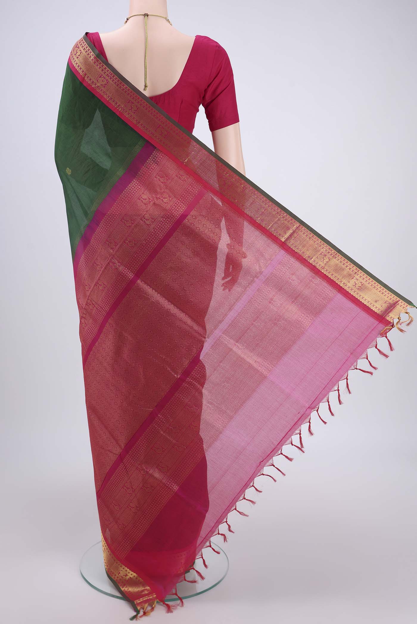 Flat view of Bottle Green Silk Cotton Saree with Zari Butta on the body and Zari Border. 