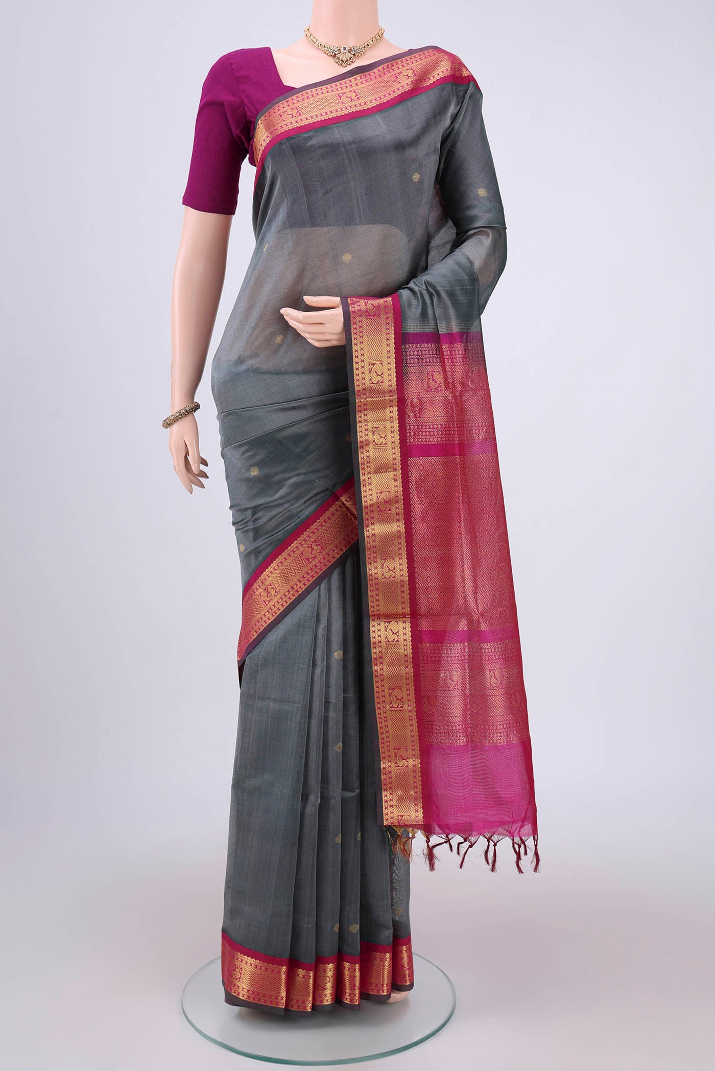 Grey Silk Cotton Saree with Zari Butta on the body and Zari Border.  displayed on a mannequin