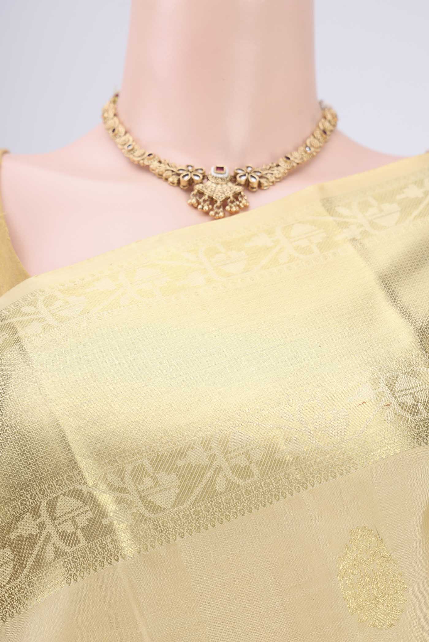 Border image of Cream Kanchipuram Silk Saree with Zari Butta on the body and Zari Border. 