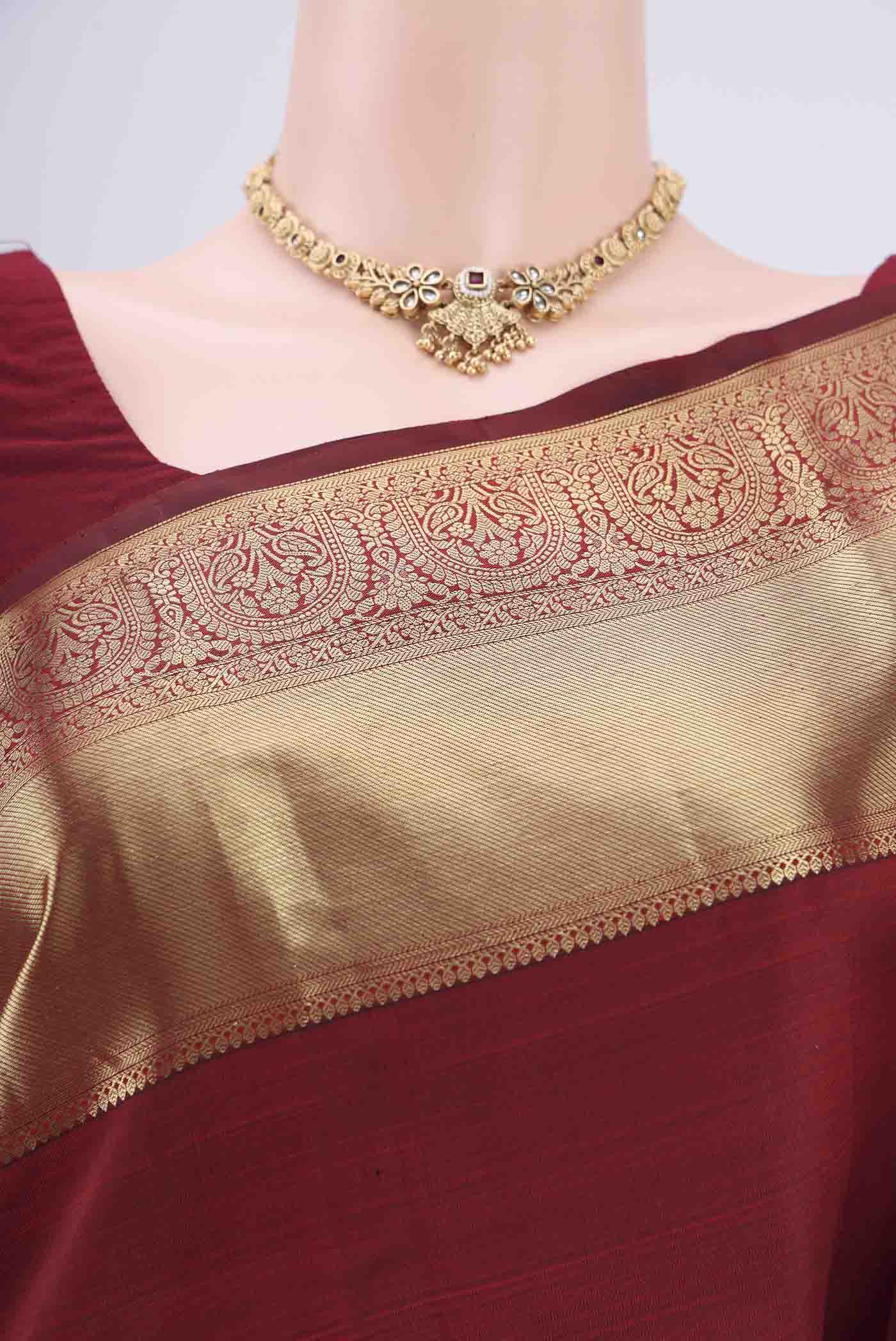 Border image of Maroon Kanchipuram Silk Saree with Zari Butta on the body and Zari Border. 