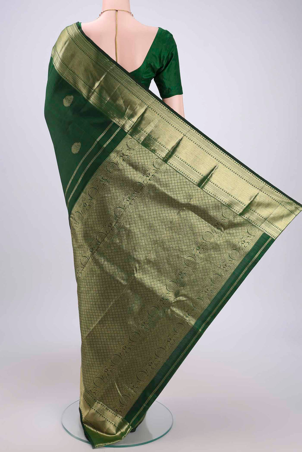 Flat view of Bottle Green Kanchipuram Silk Saree with Zari Butta on the body and Zari Border. 