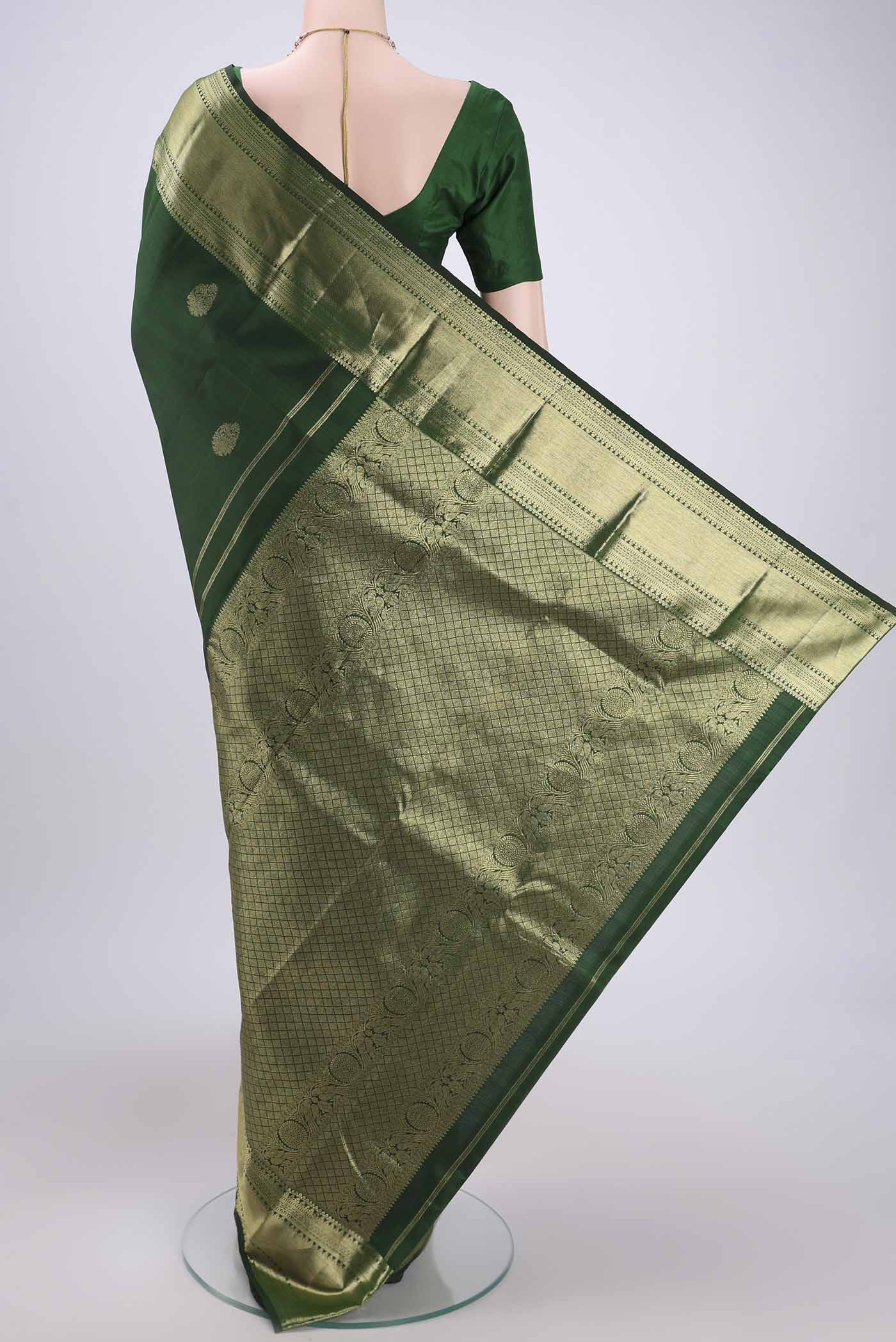 Flat view of Bottle Green Kanchipuram Silk Saree with Zari Butta on the body and Zari Border. 