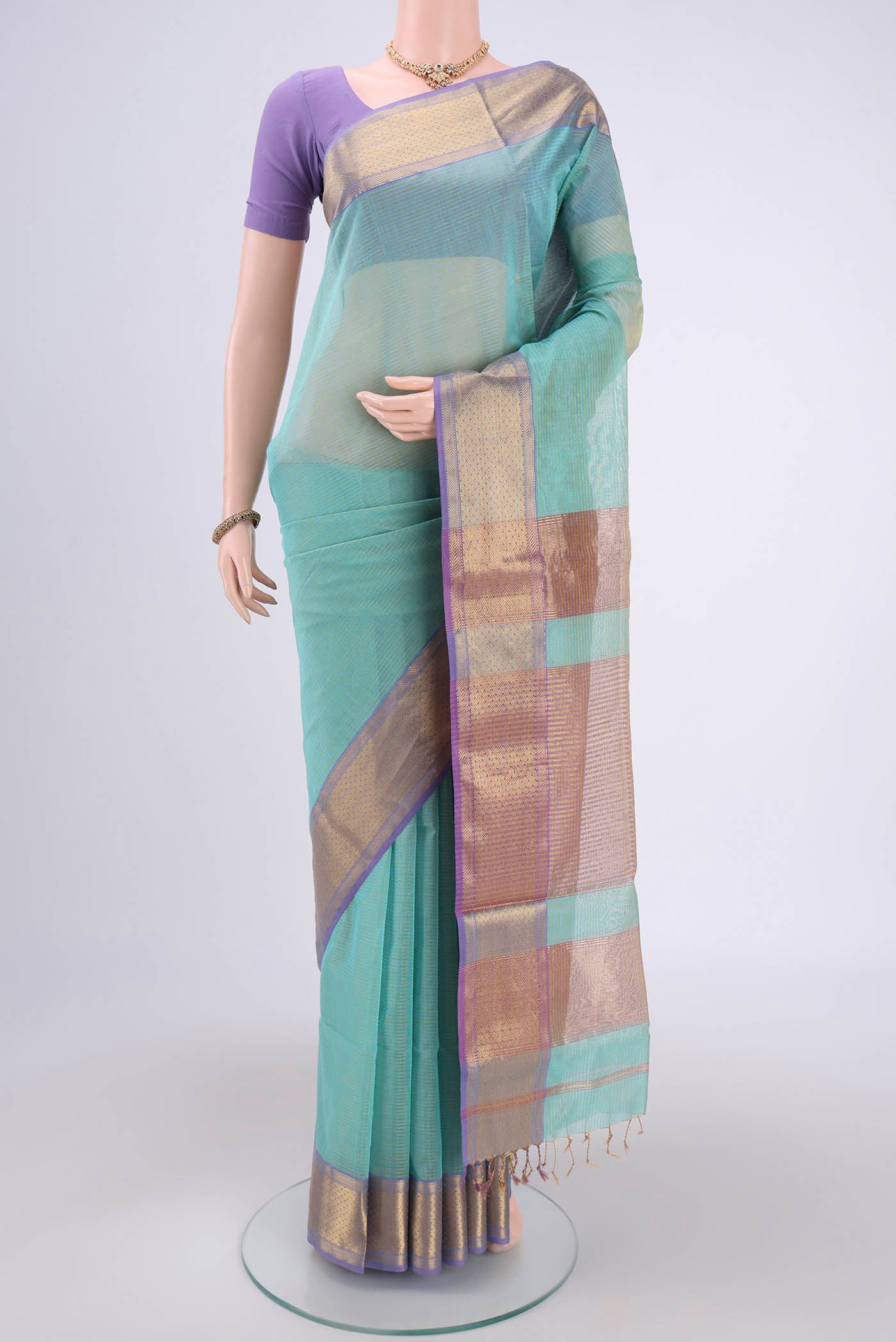 Sky Blue Maheshwari Silk Cotton Saree with Zari And Thread Butta on the body and Zari Border.  displayed on a mannequin