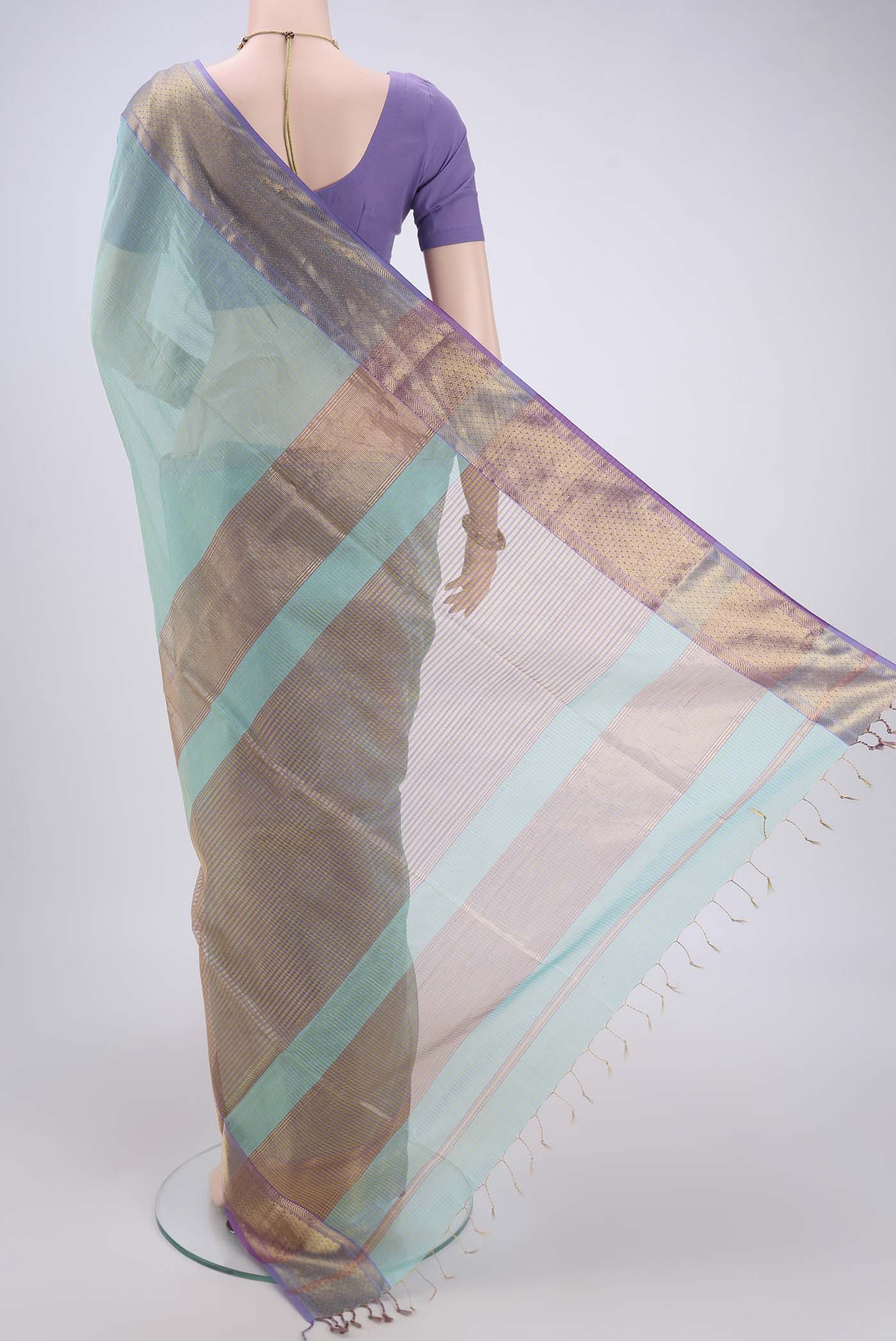 Flat view of Sky Blue Maheshwari Silk Cotton Saree with Zari And Thread Butta on the body and Zari Border. 